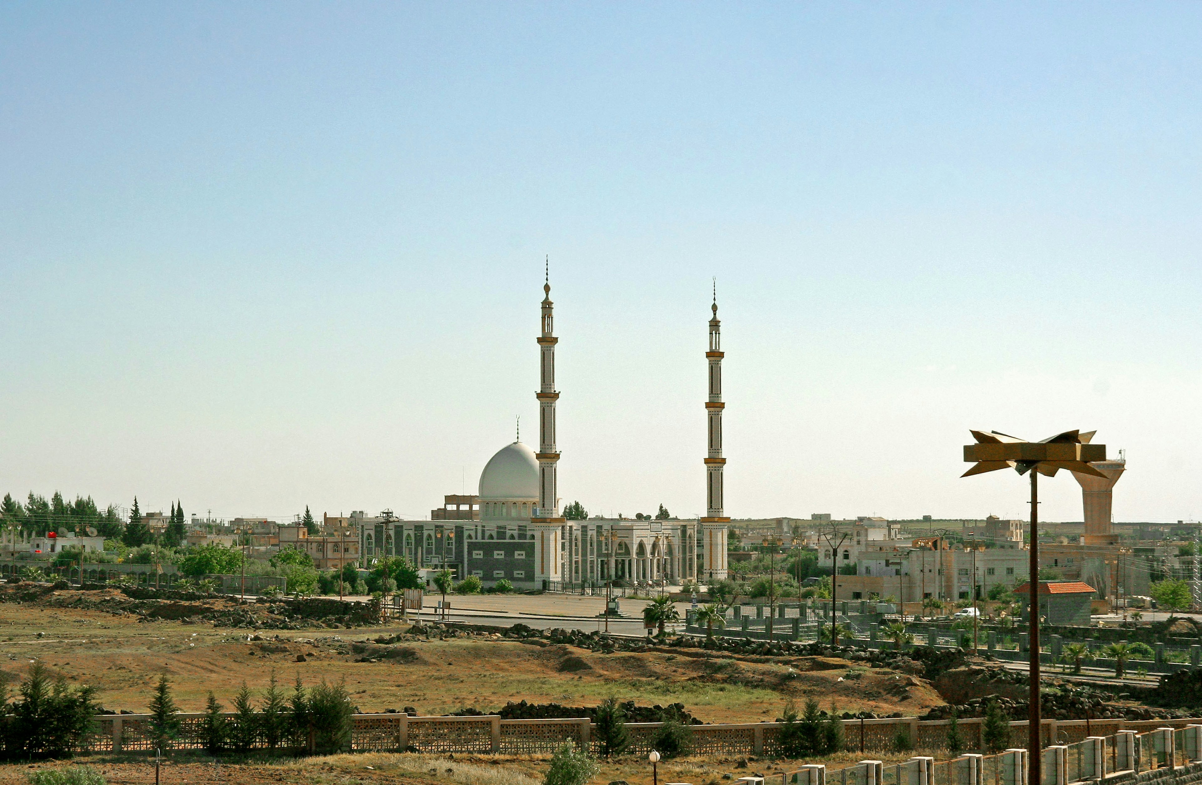 Scenic view of a mosque with minarets in a desert landscape