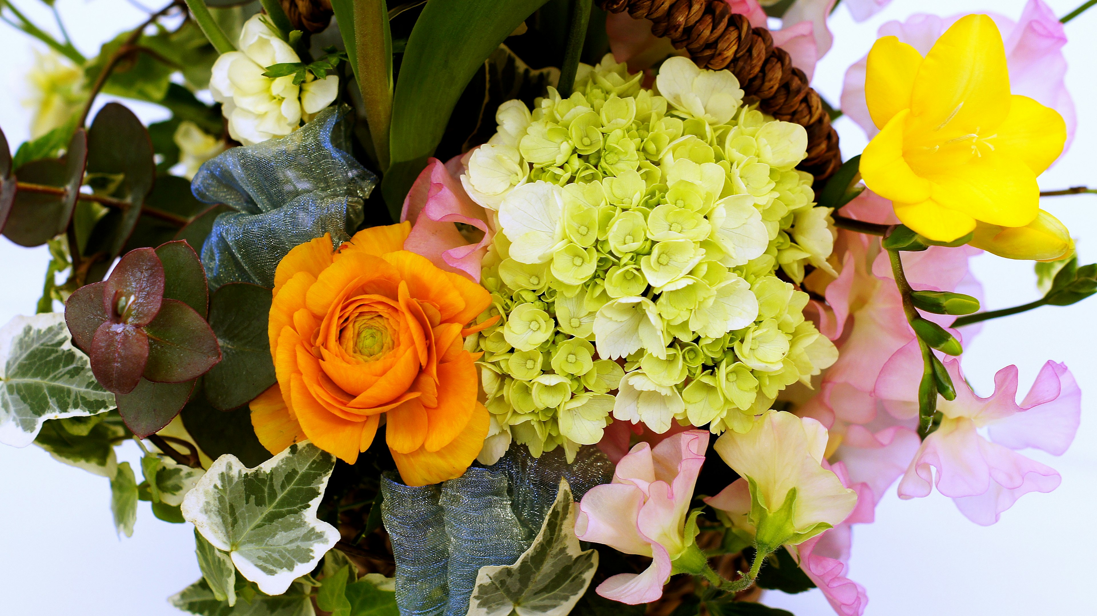 A beautiful arrangement of colorful flowers including yellow, orange, and green hues