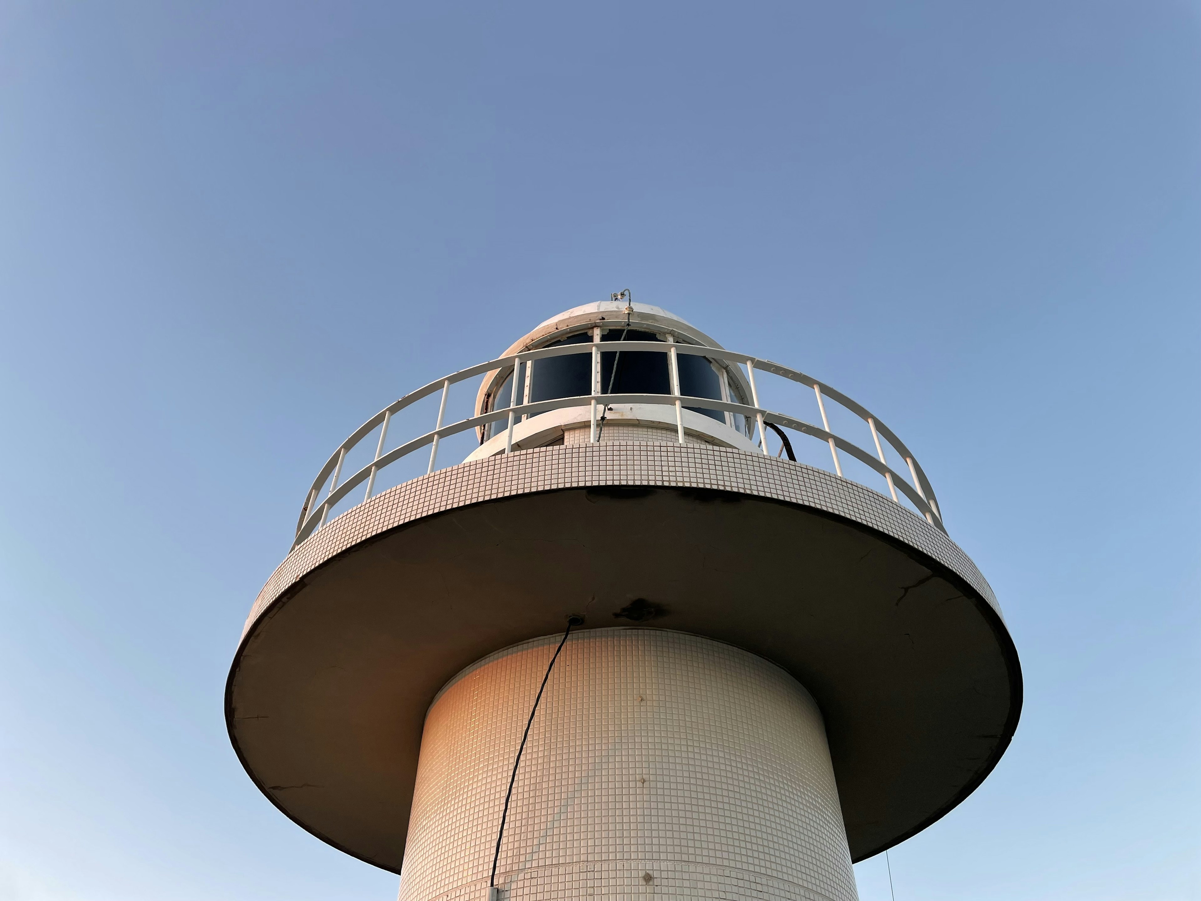 Primo piano di un faro sotto un cielo blu chiaro