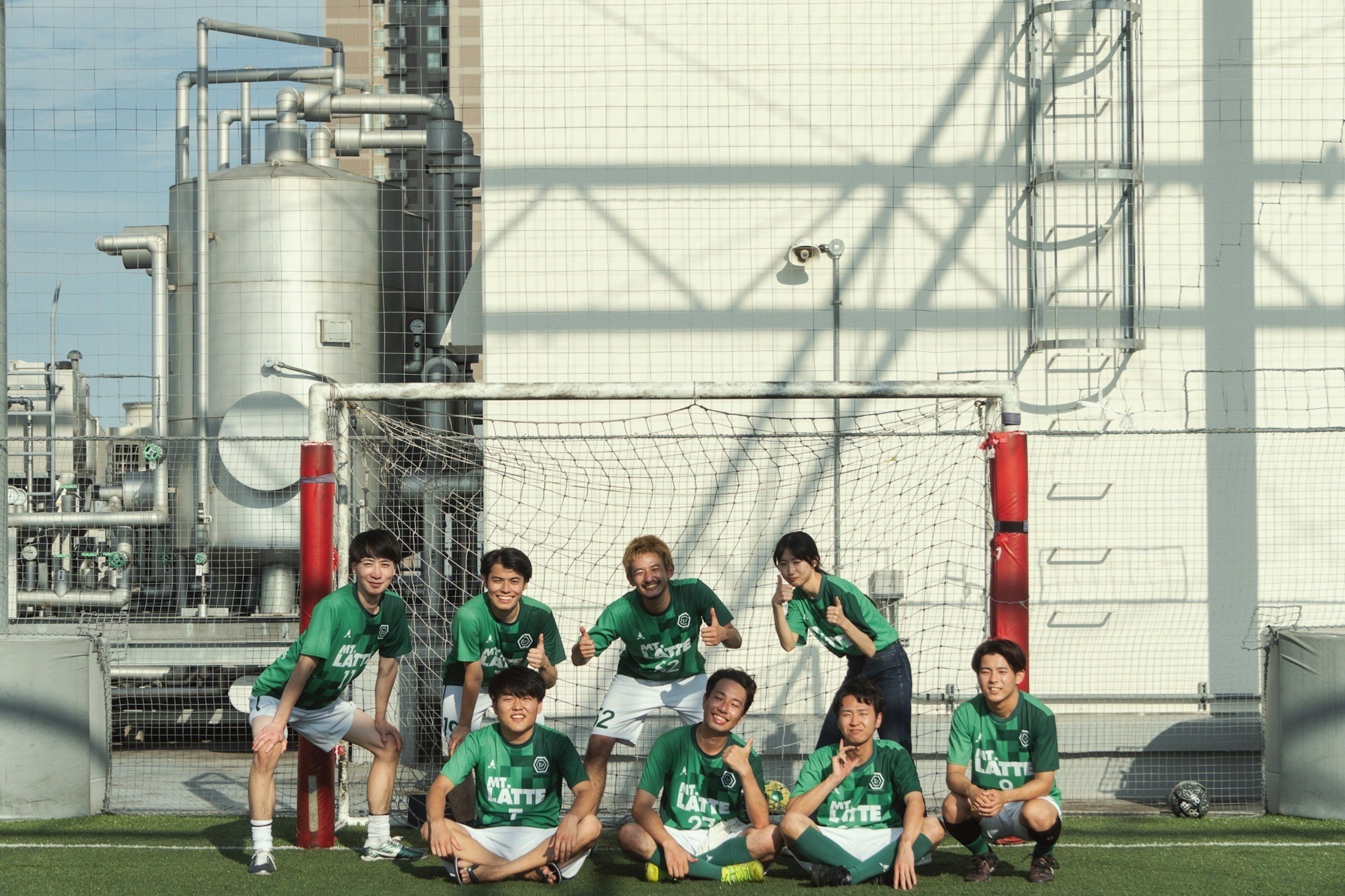 A soccer team posing for a photo on a field