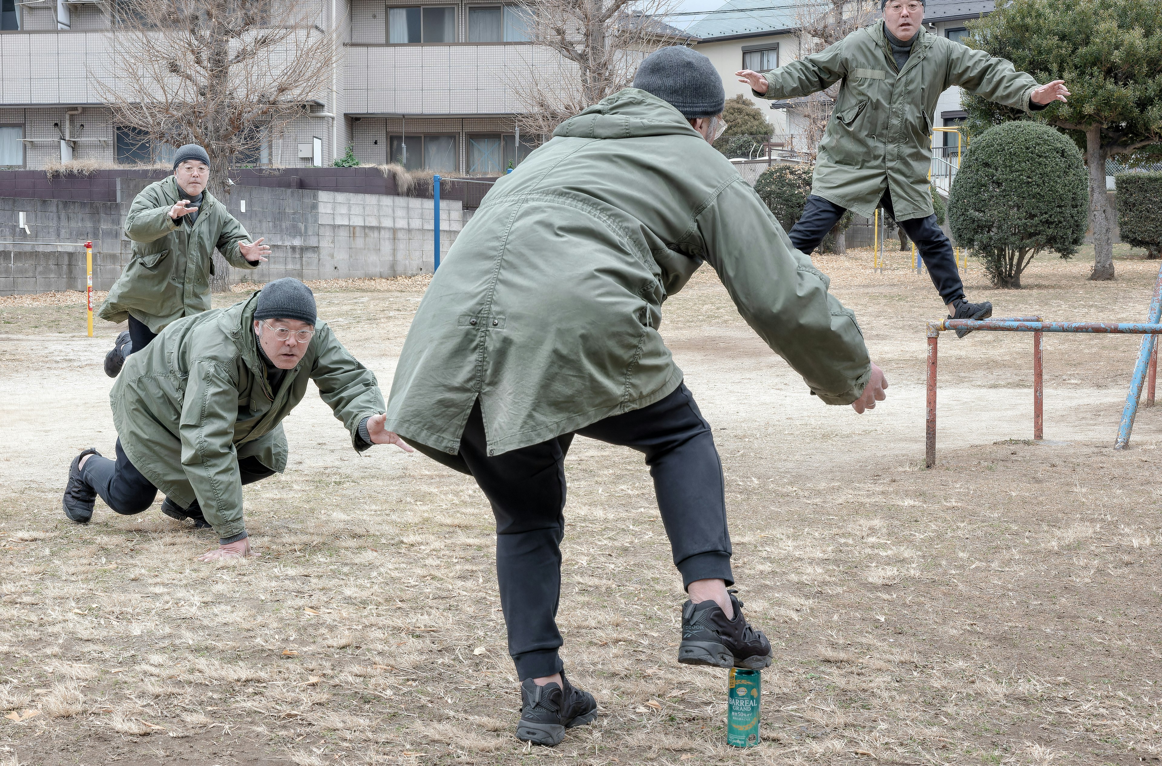 A group of people in green coats running in a park