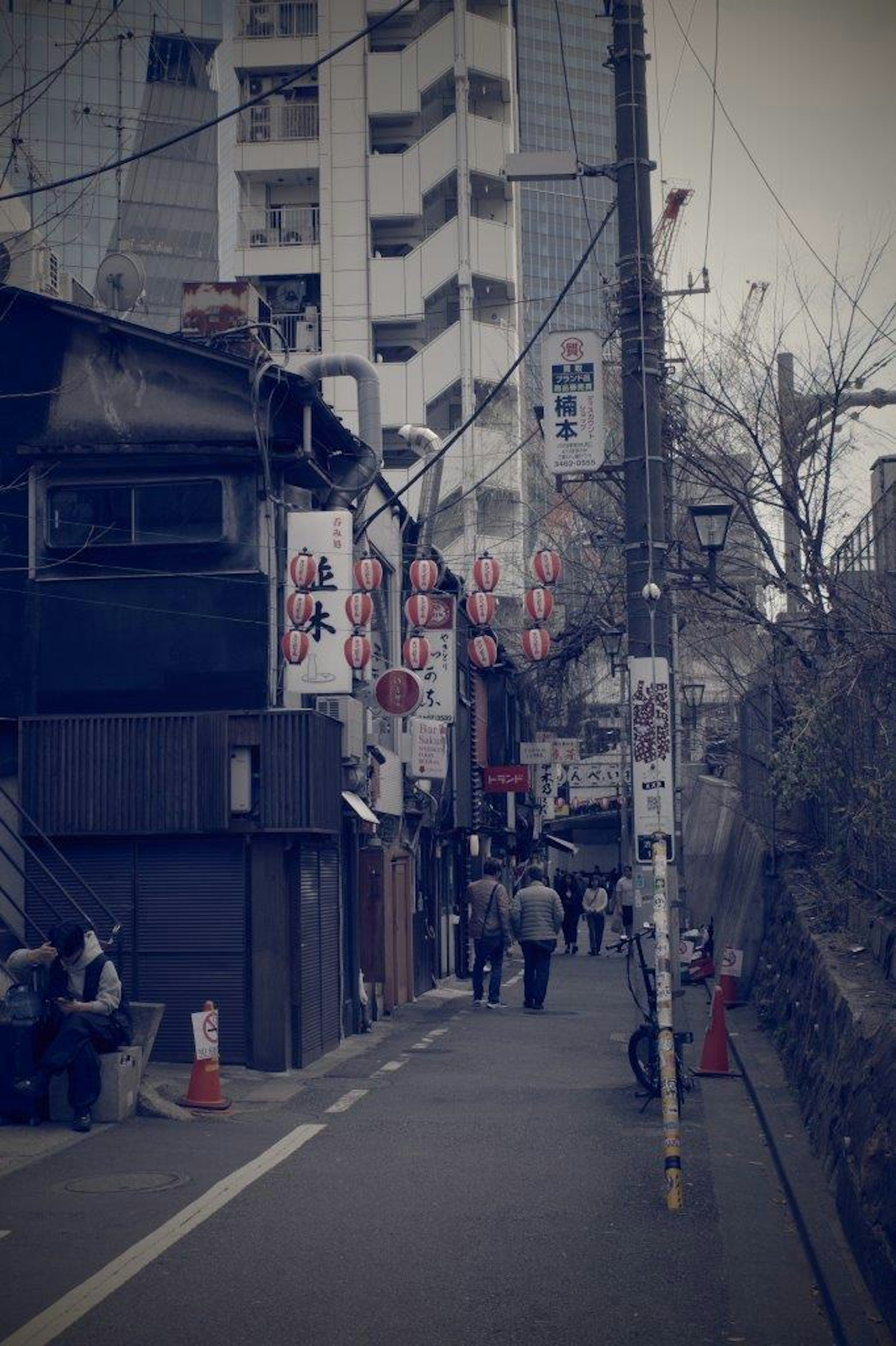 Urban street lined with eateries and pedestrians