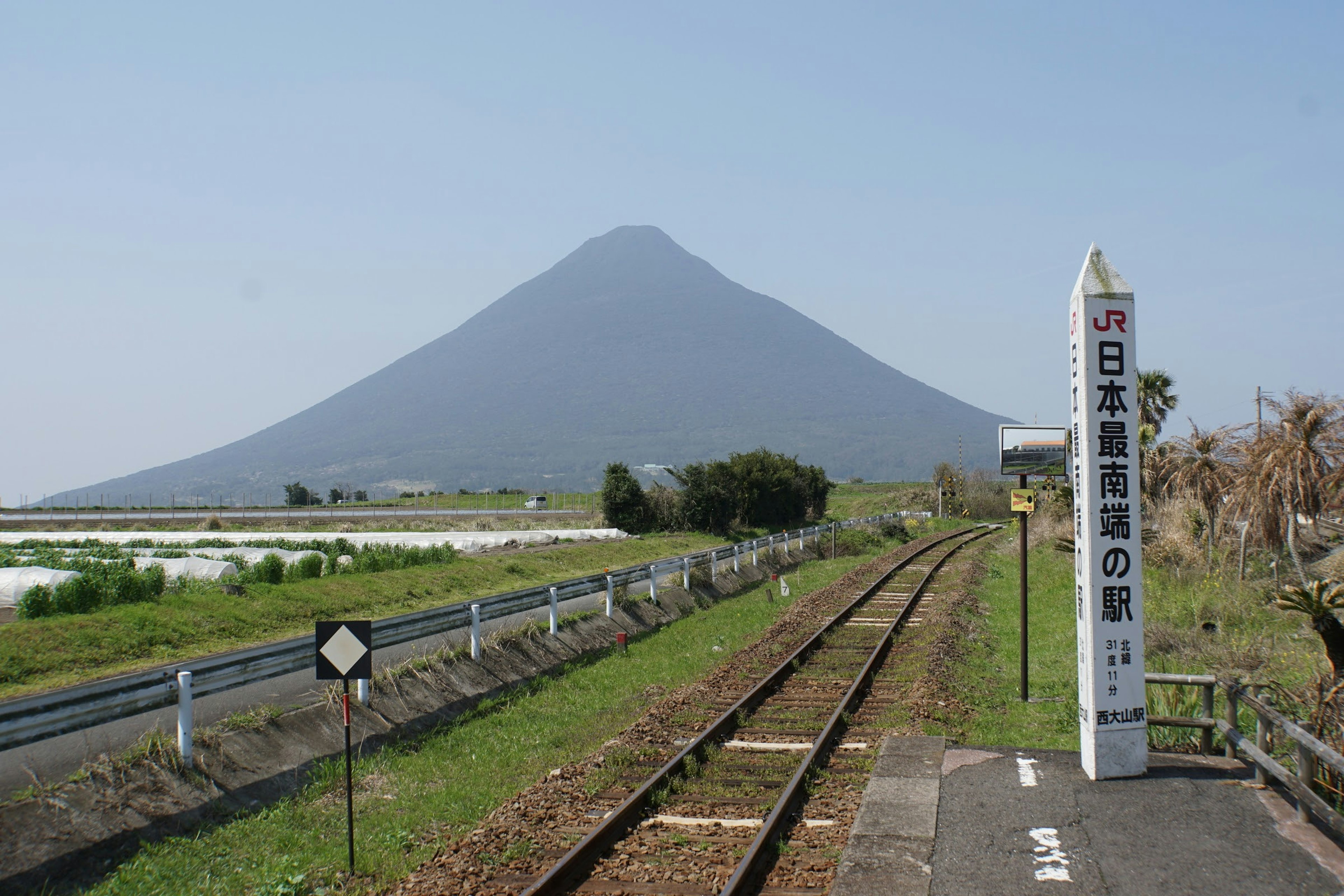 Scenic countryside with a mountain in the background and railway tracks