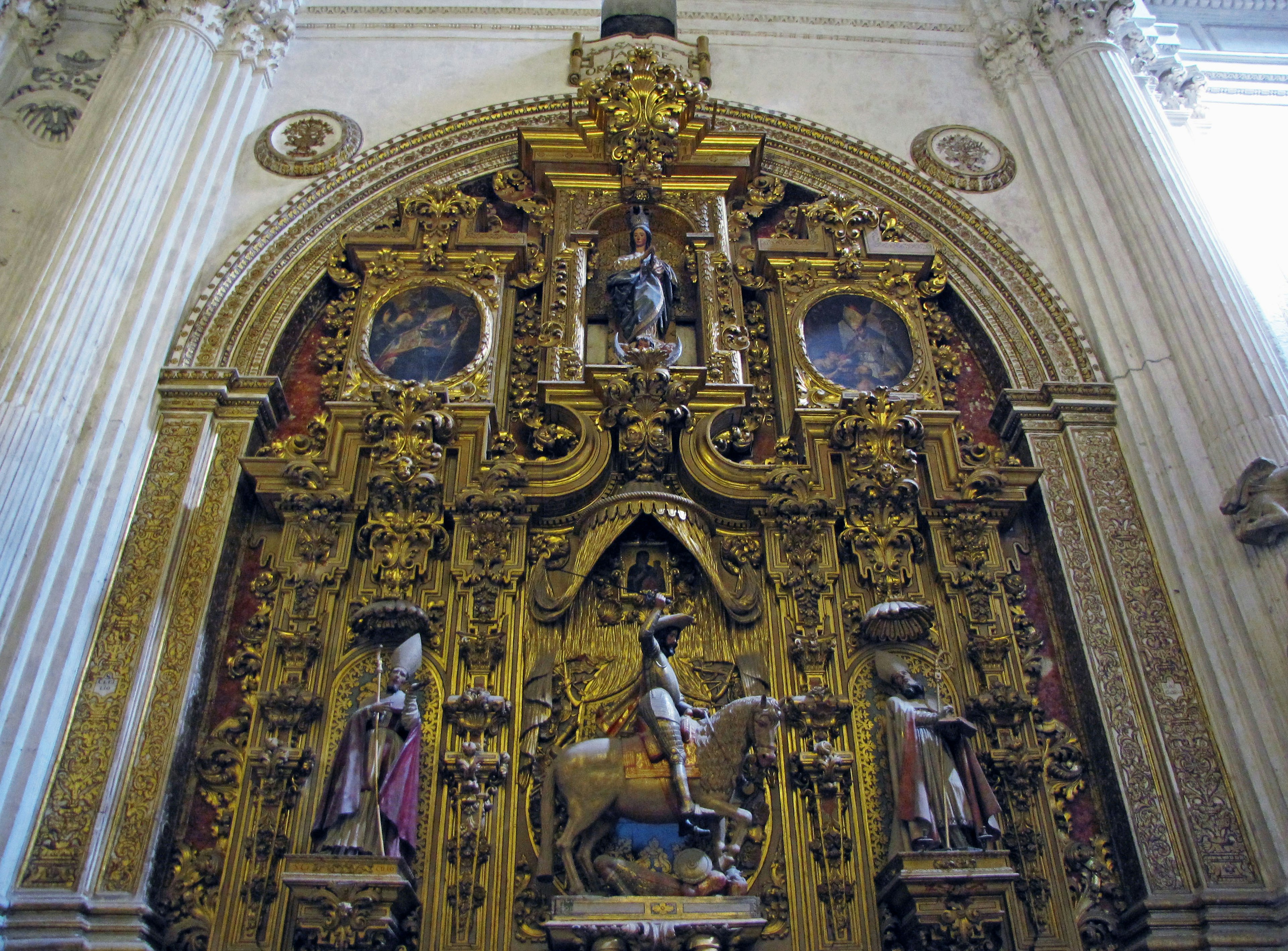 Decorative golden altar with intricate carvings in a church interior