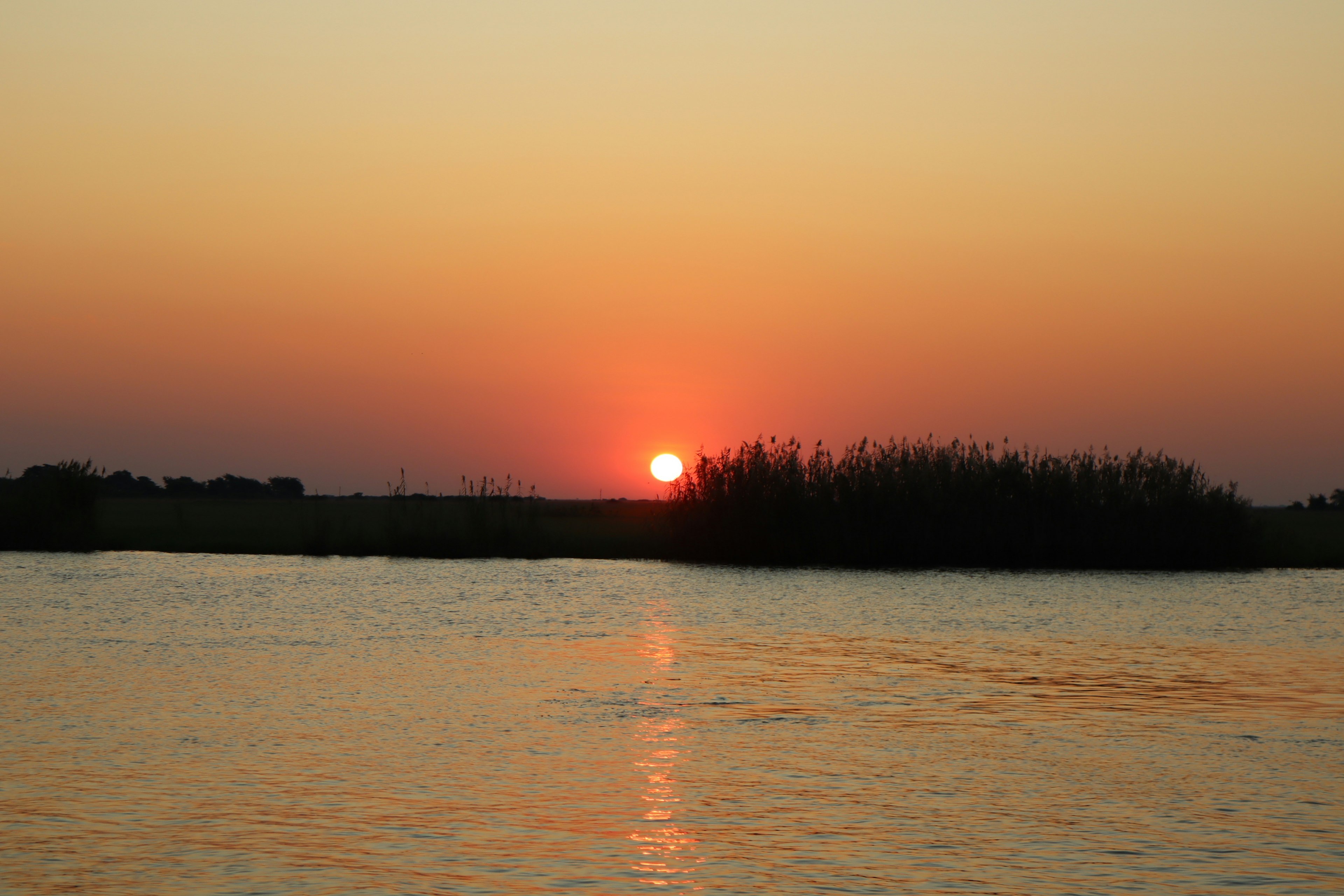 Scenic view of a sunset reflecting on water