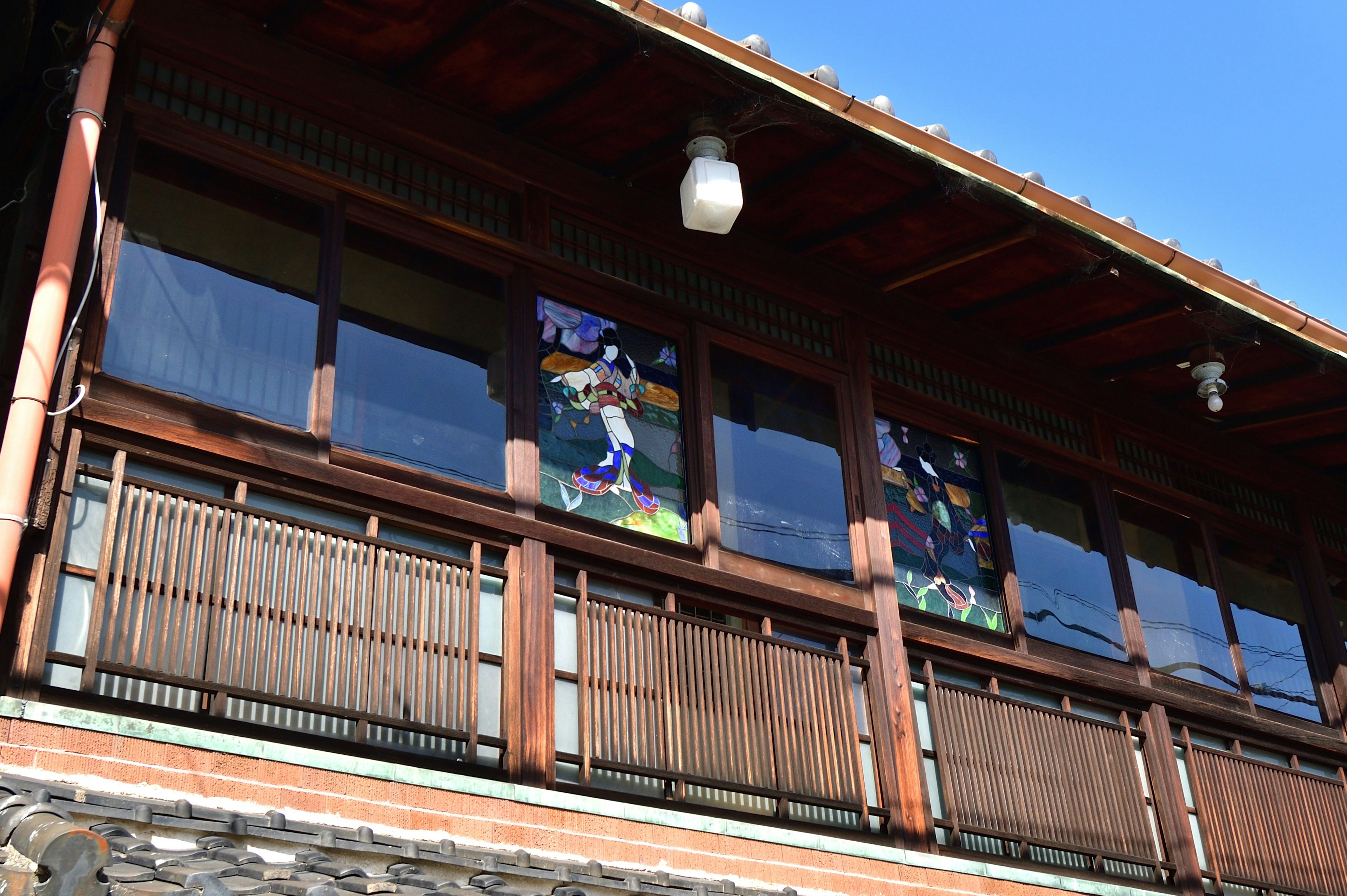 Traditional building with colorful fabric hanging in the second-floor windows