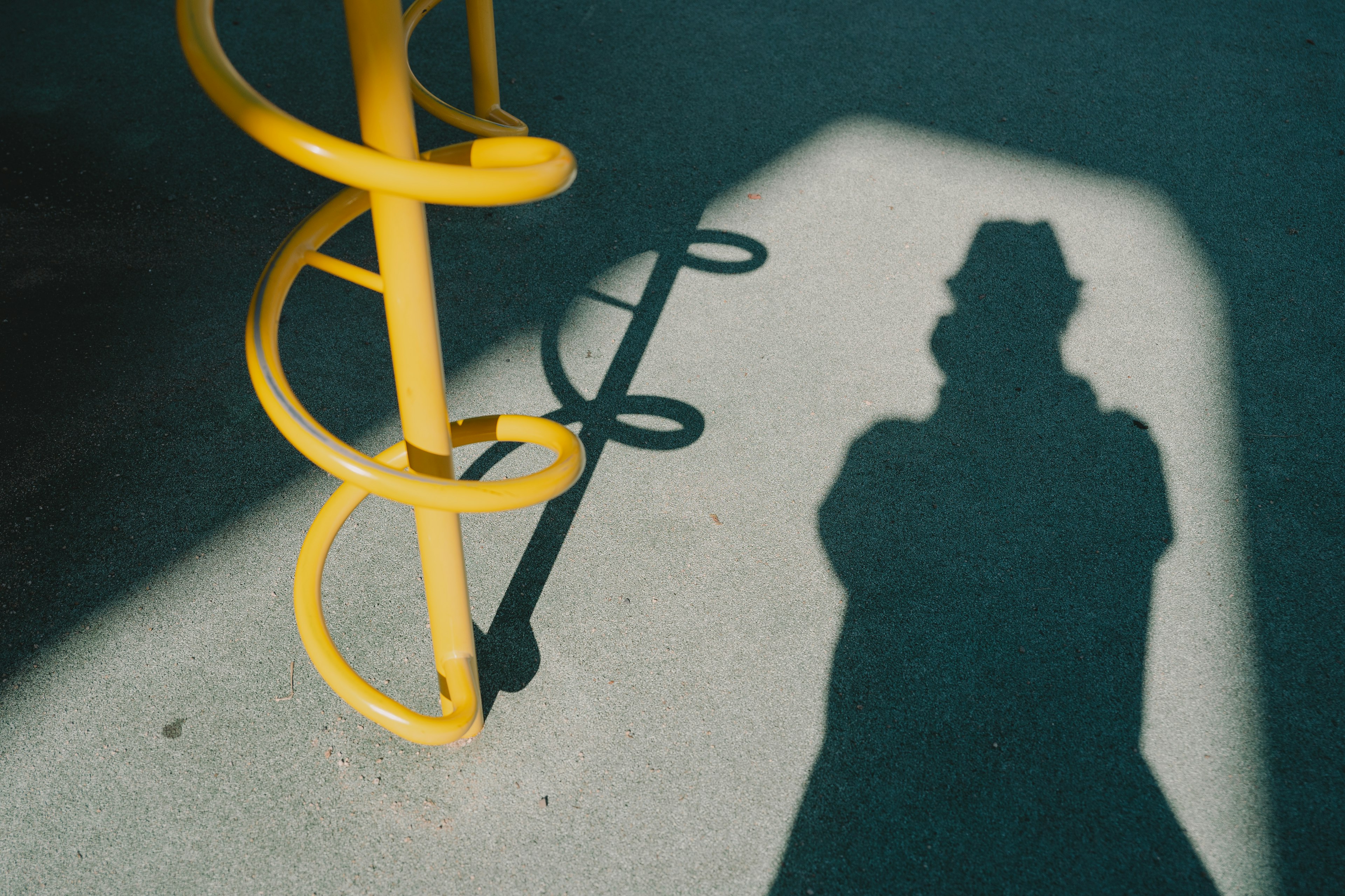 Contrast of yellow spiral and human shadow