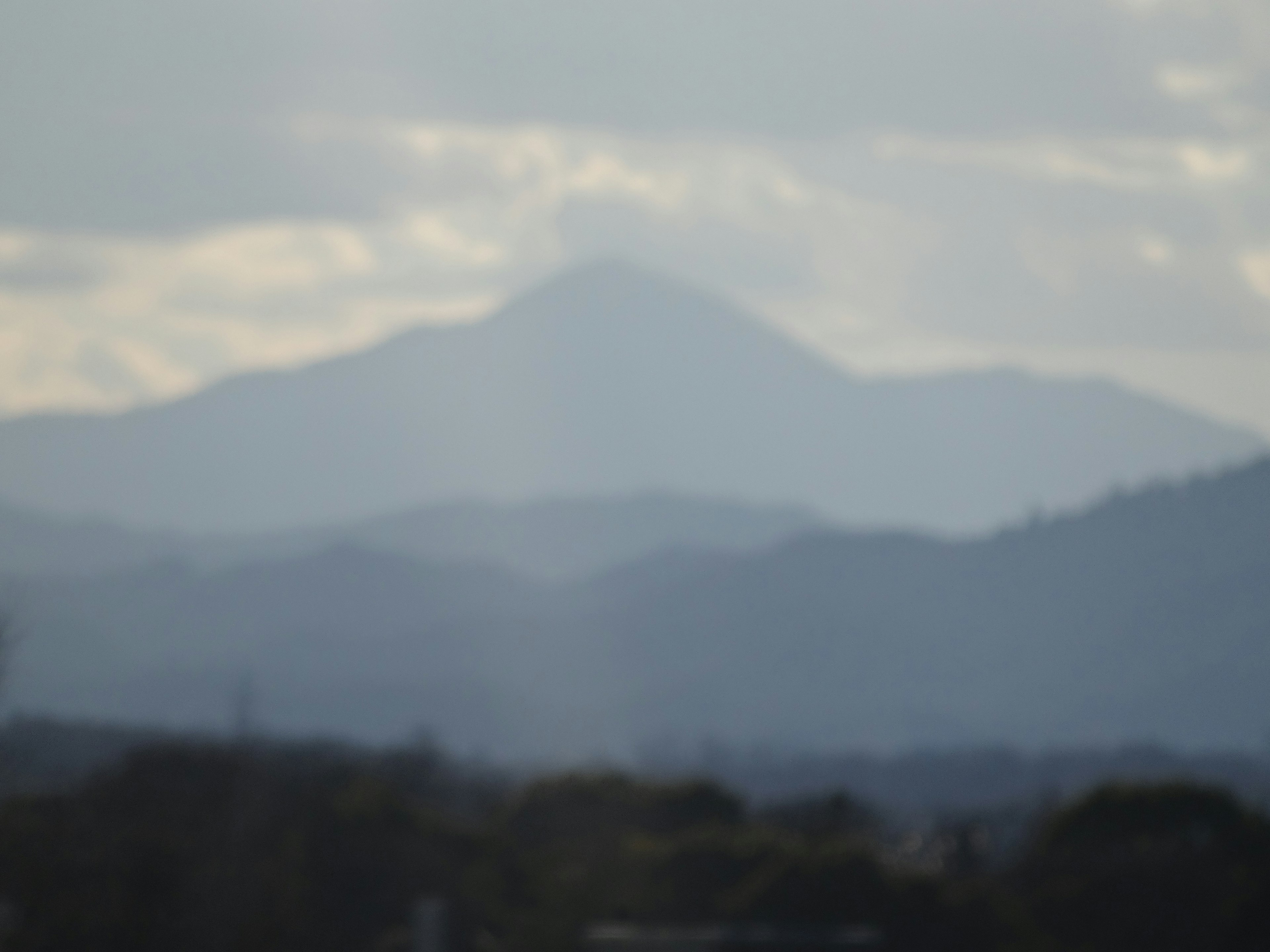 Silhouette of mountains under a cloudy sky