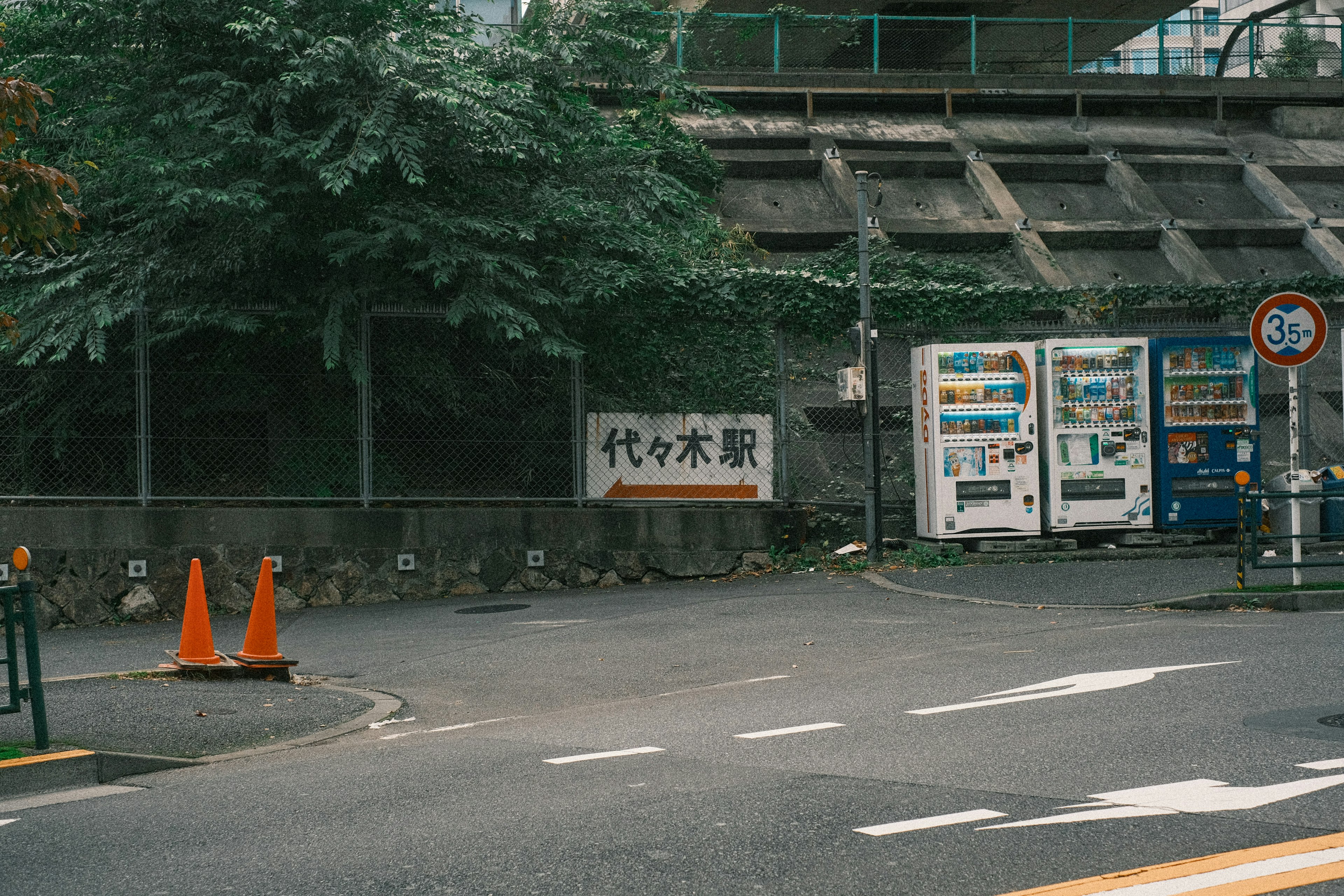 Straßenecke mit Yoyogi-Wasserwerks-Schild und Verkaufsautomaten