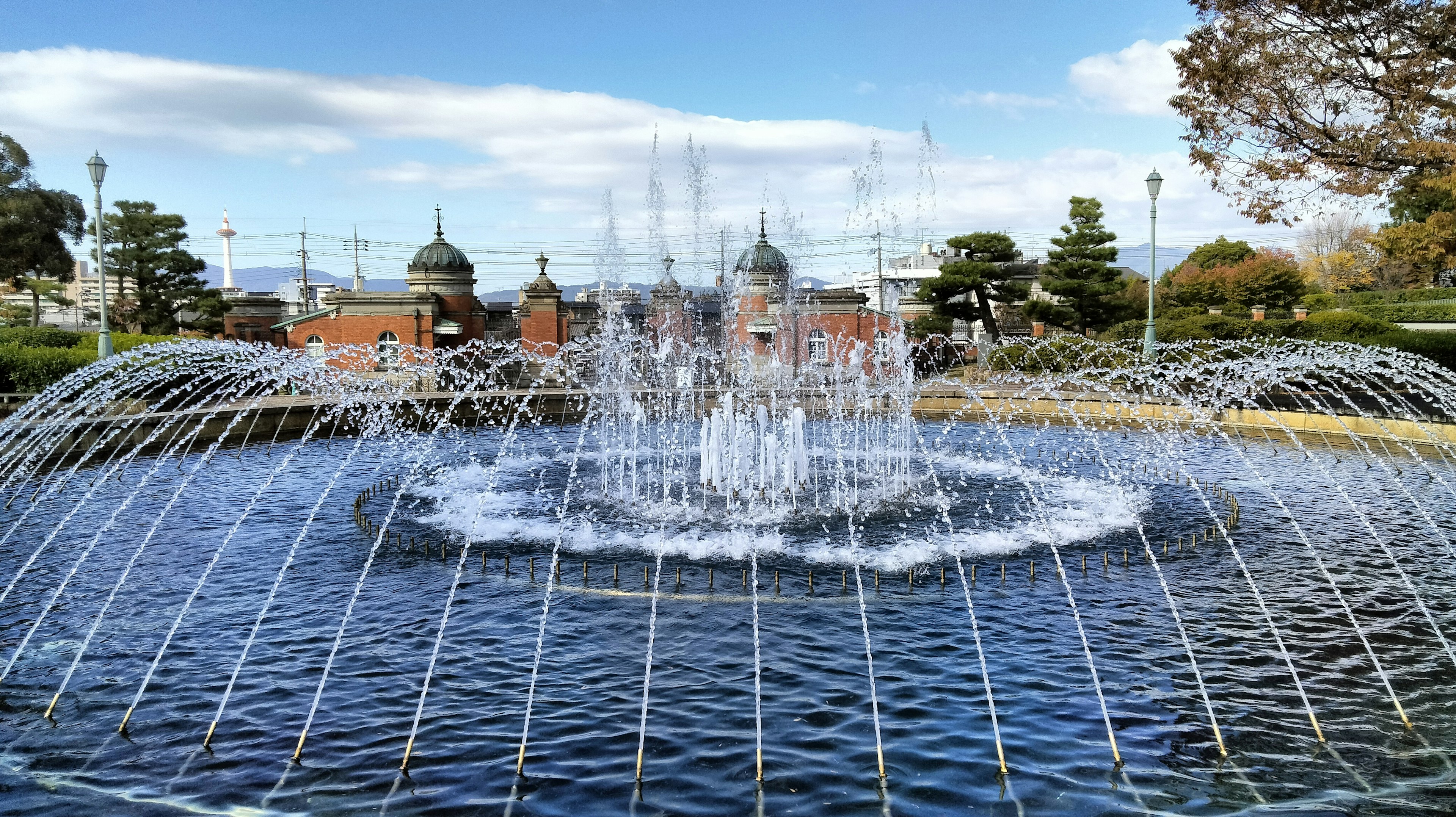 Beautiful fountain in a park with water spraying in arcs