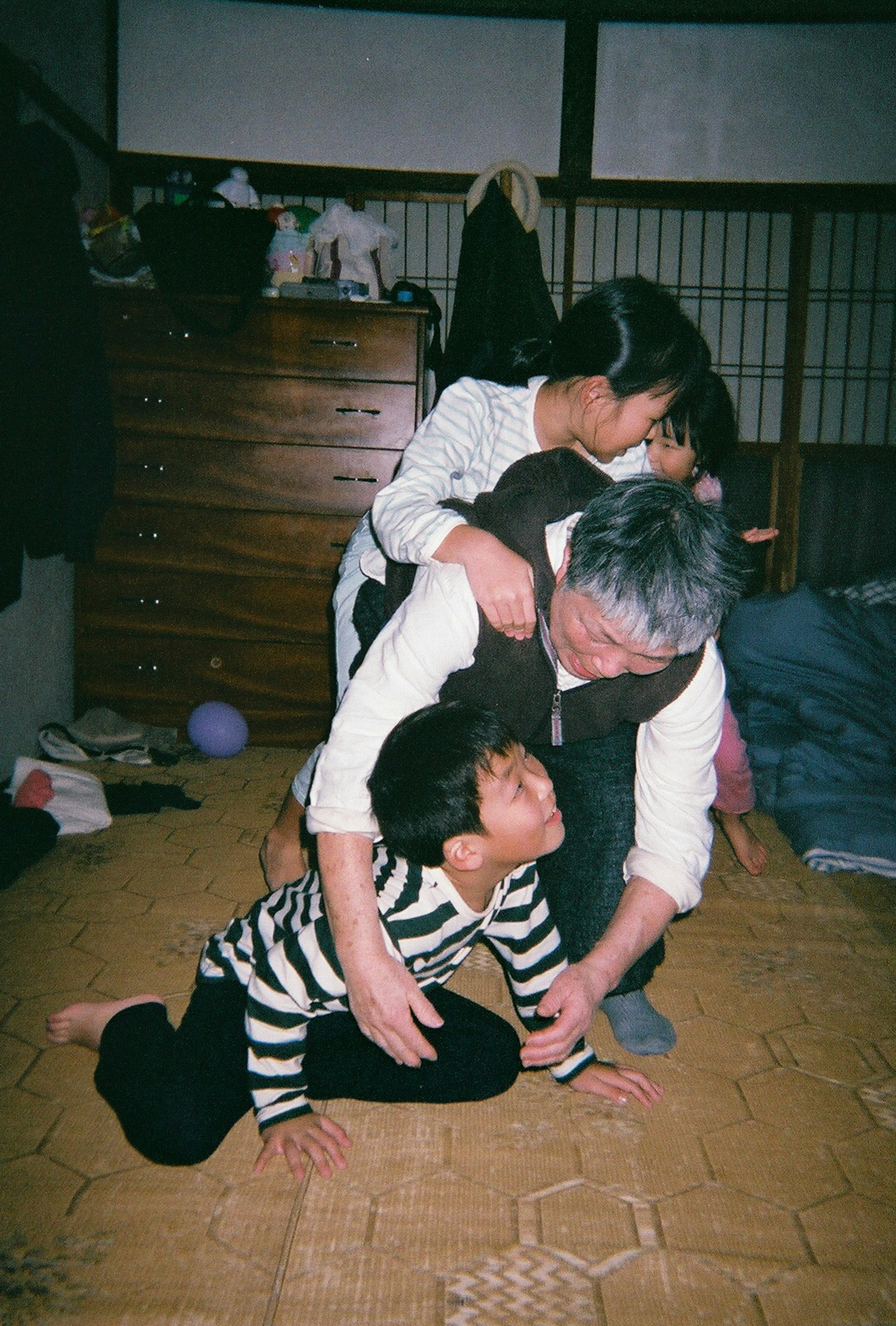 A heartwarming scene of an elderly man playing with children