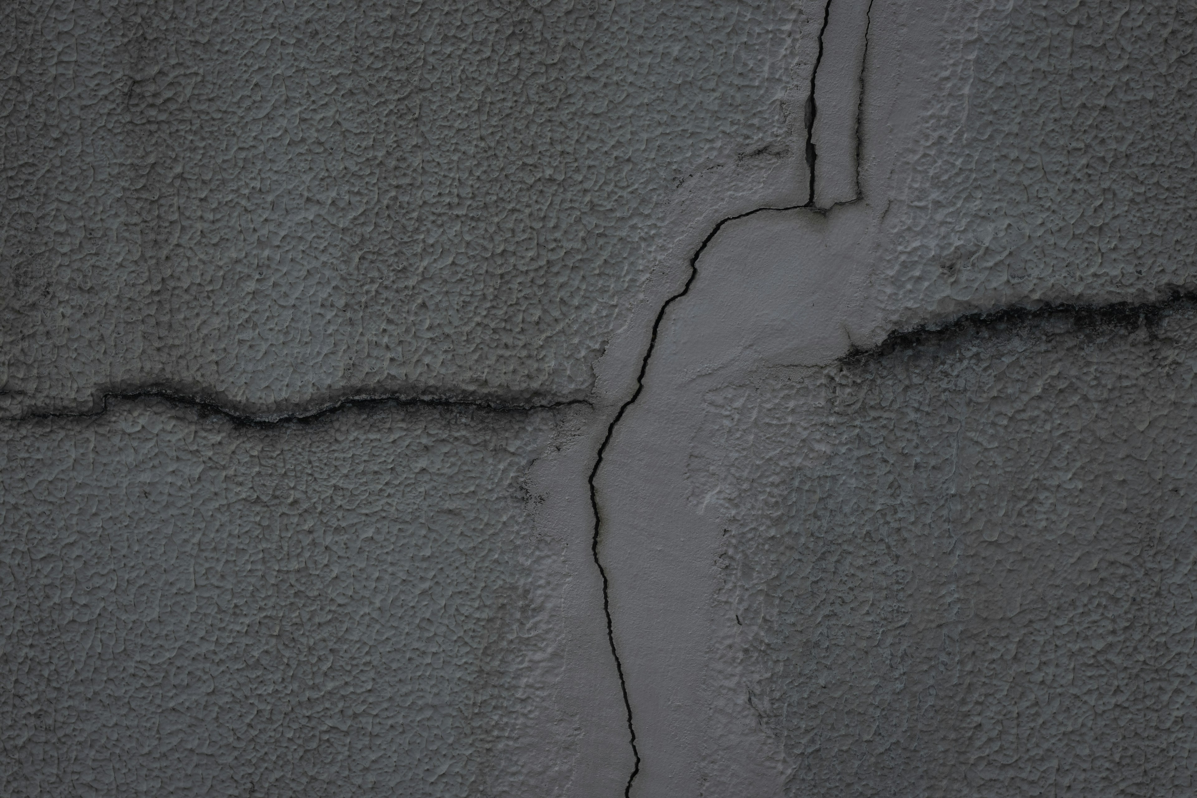 Cracked gray wall texture with visible seams