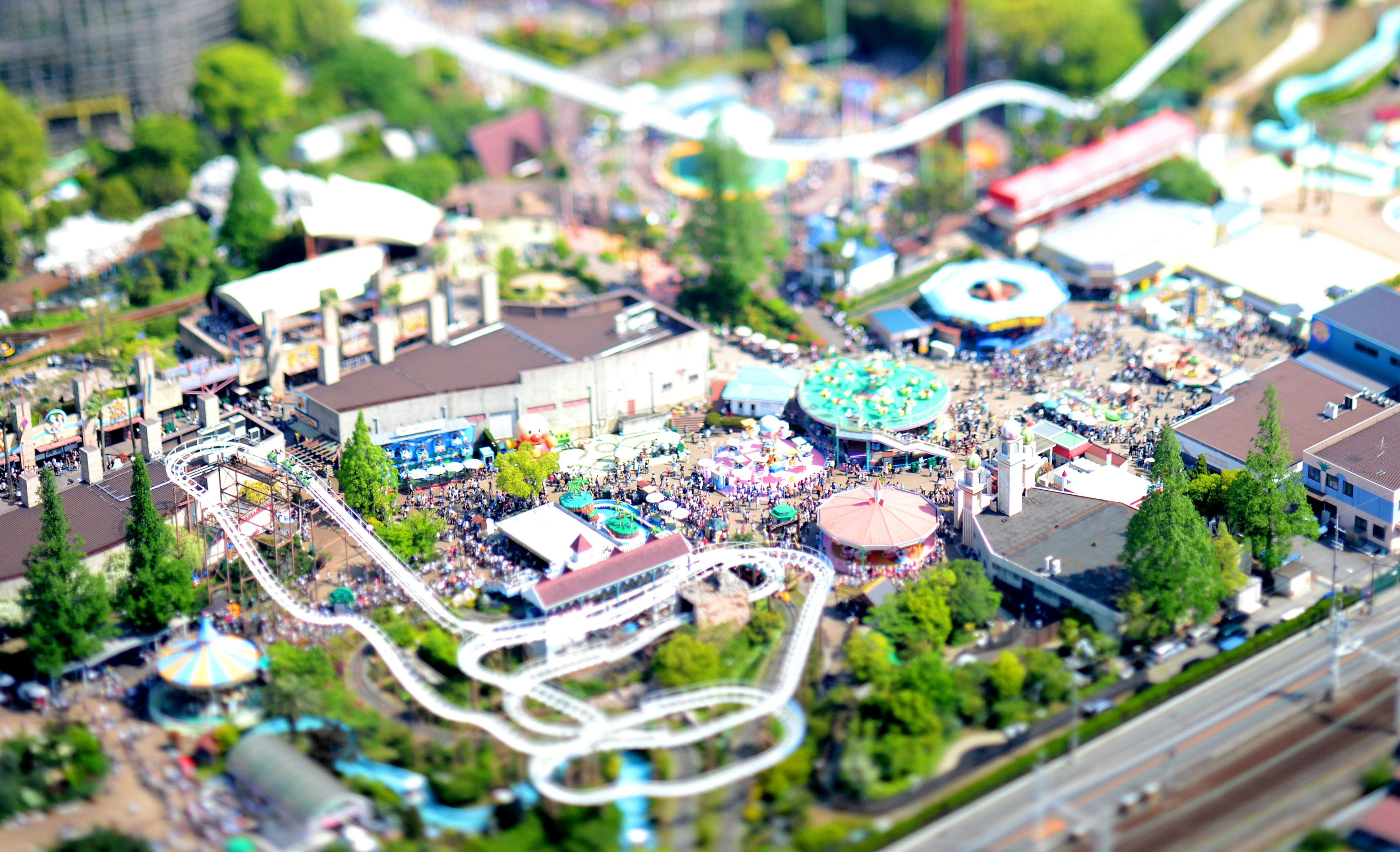 Aerial view of an amusement park with crowds and attractions