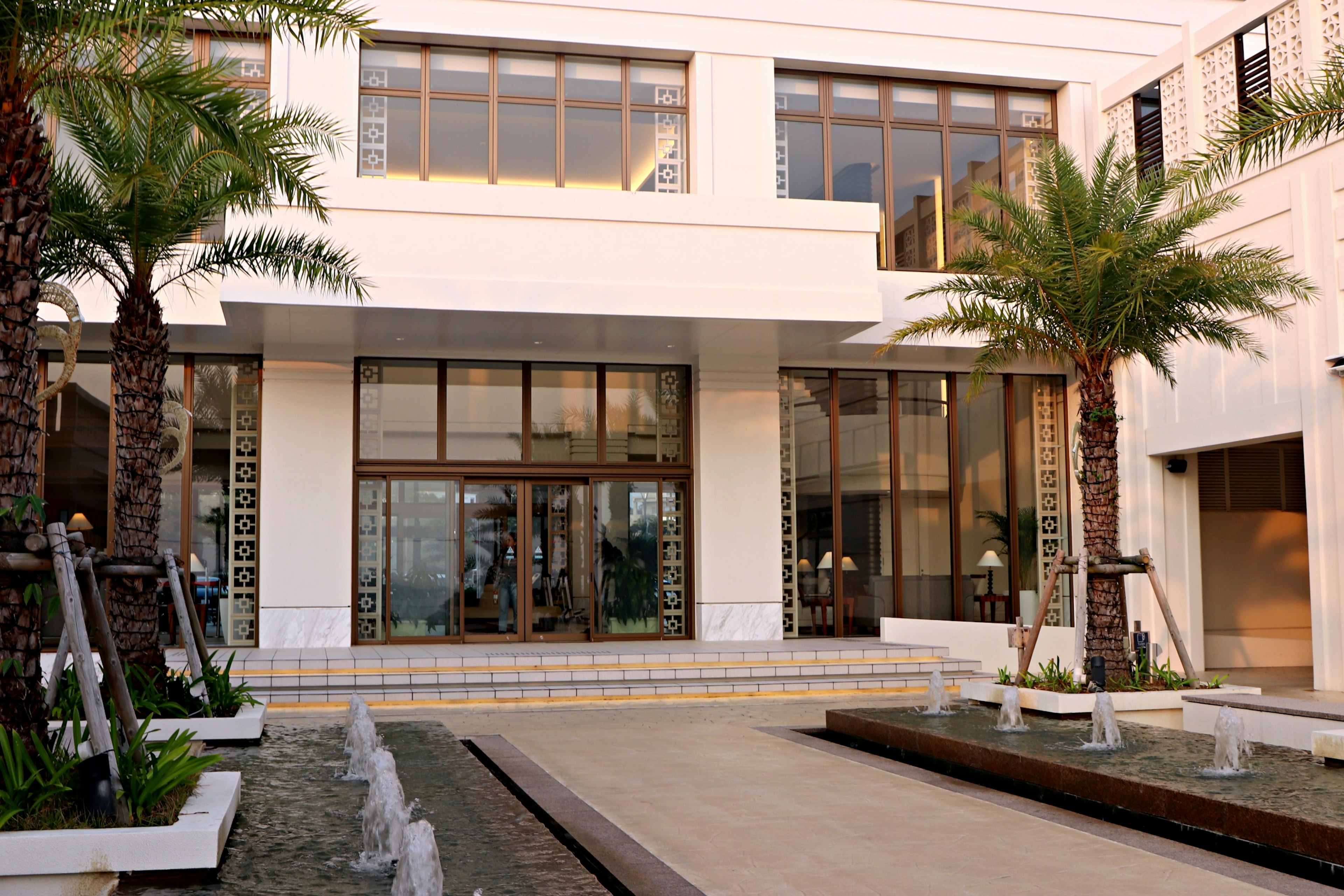 Modern building entrance with palm trees