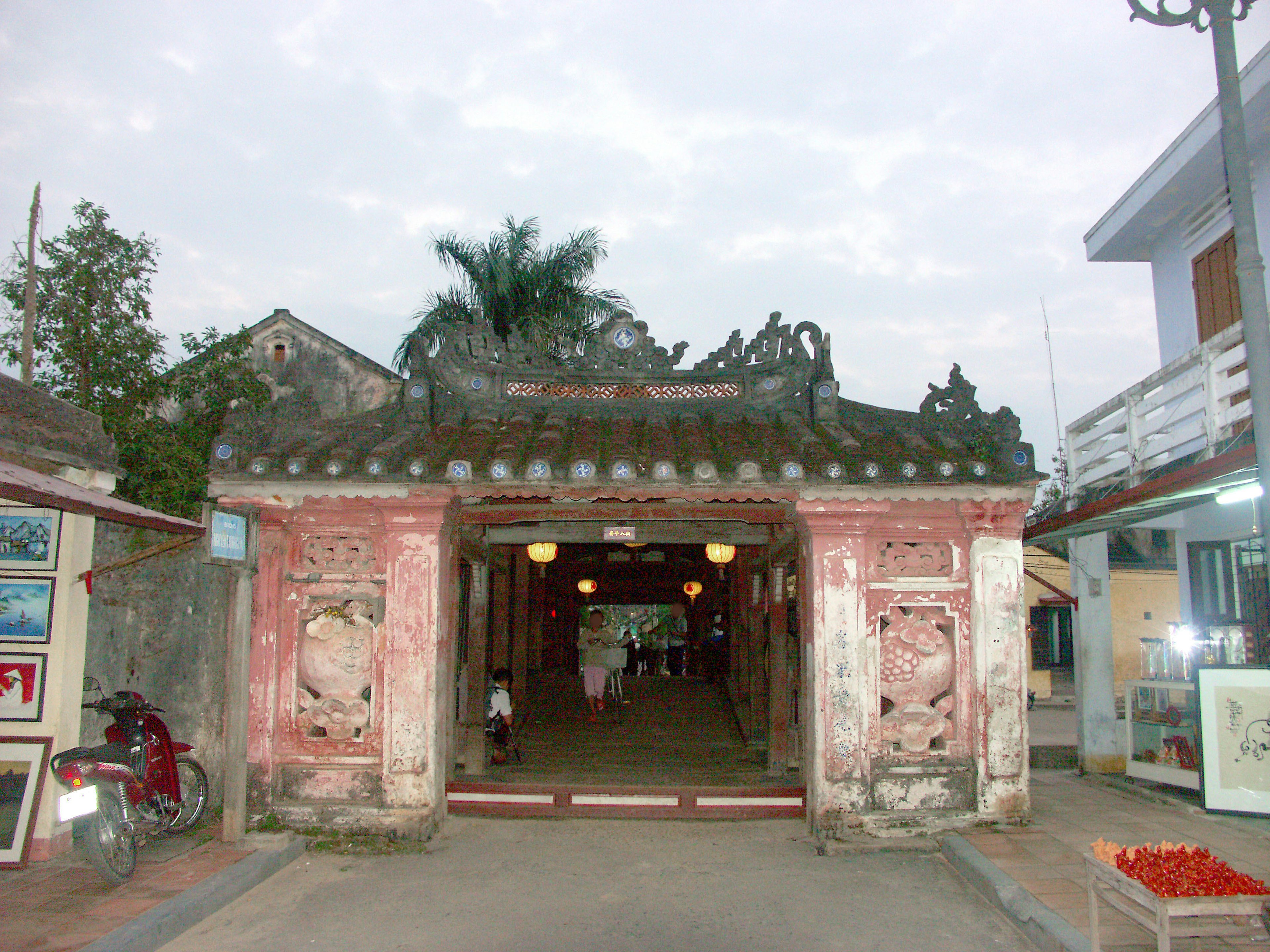 Traditional archway entrance with old buildings and greenery surrounding it