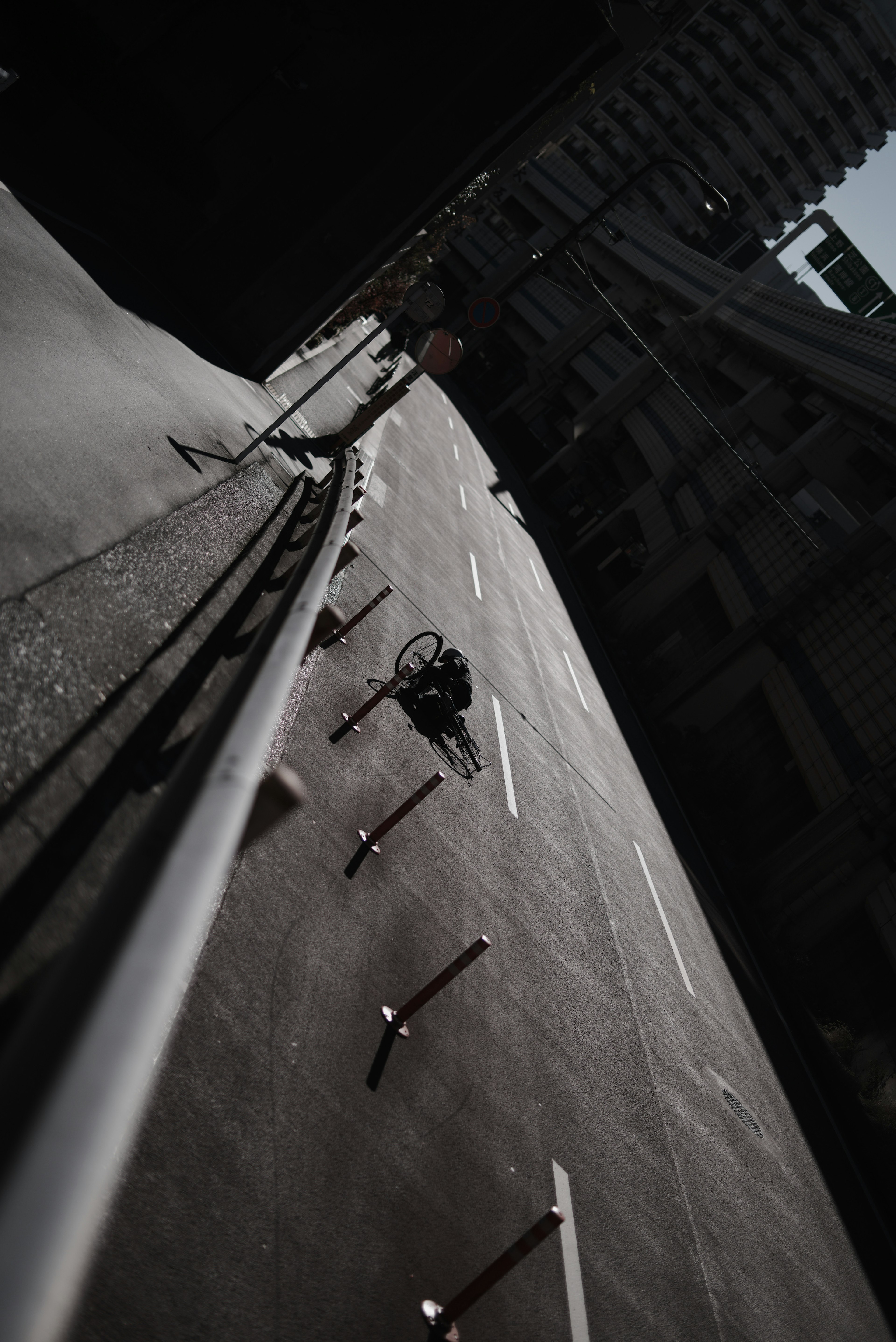 Tilted street view with railing and urban surroundings