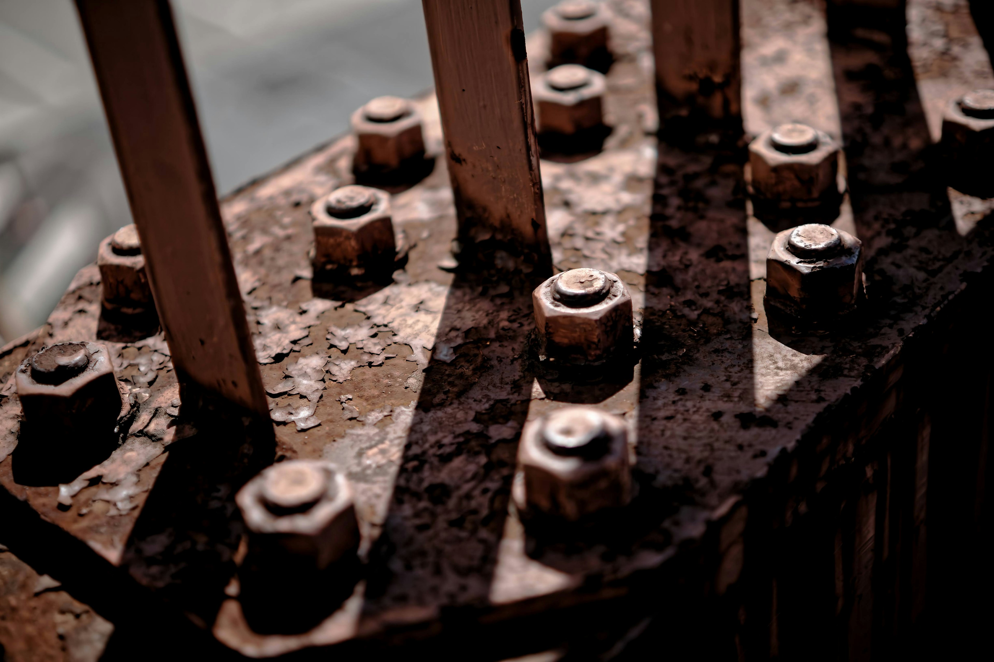 Close-up of rusty nuts and metal bars in a structure