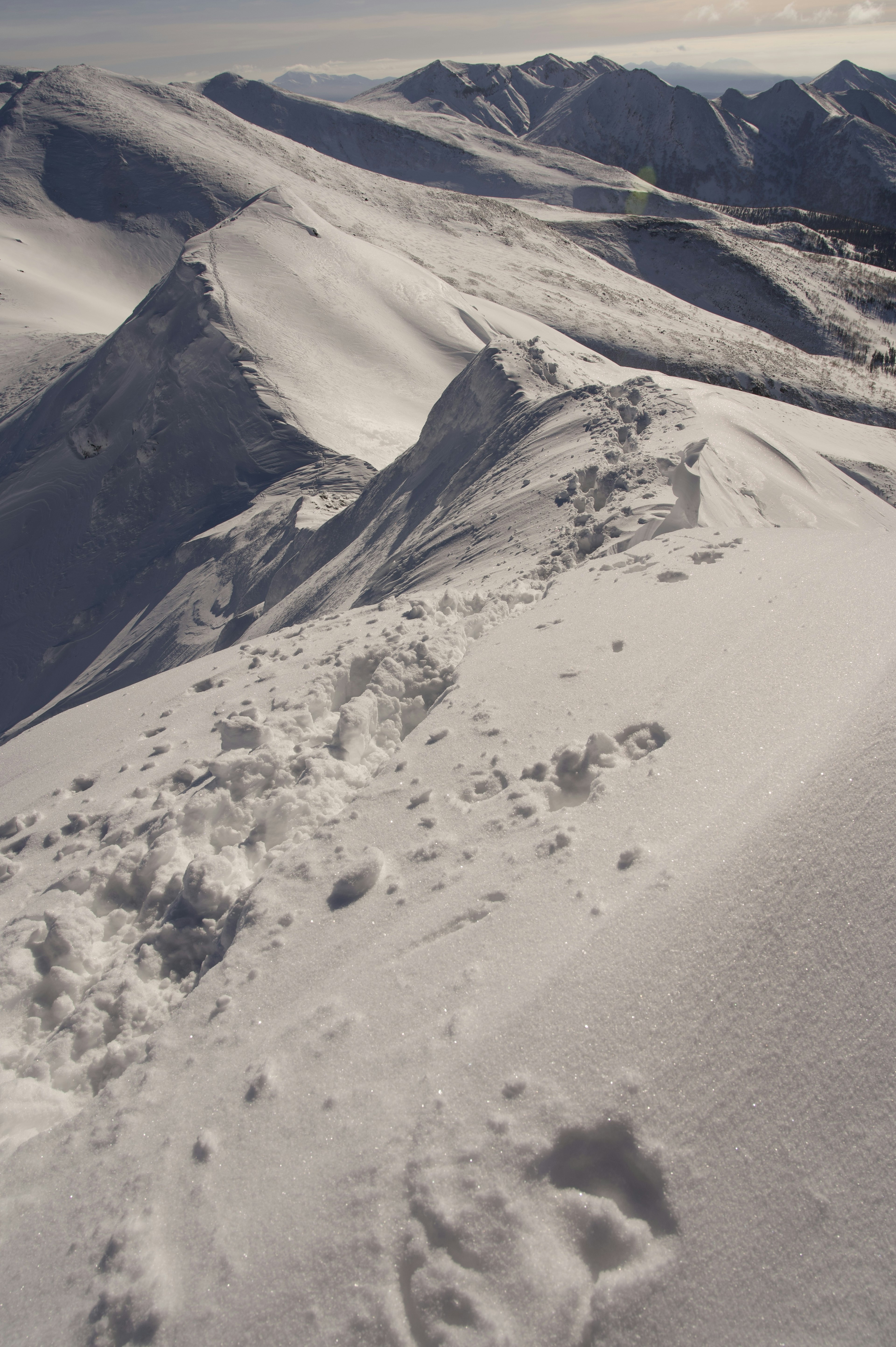 Snow-covered mountain landscape with footprints