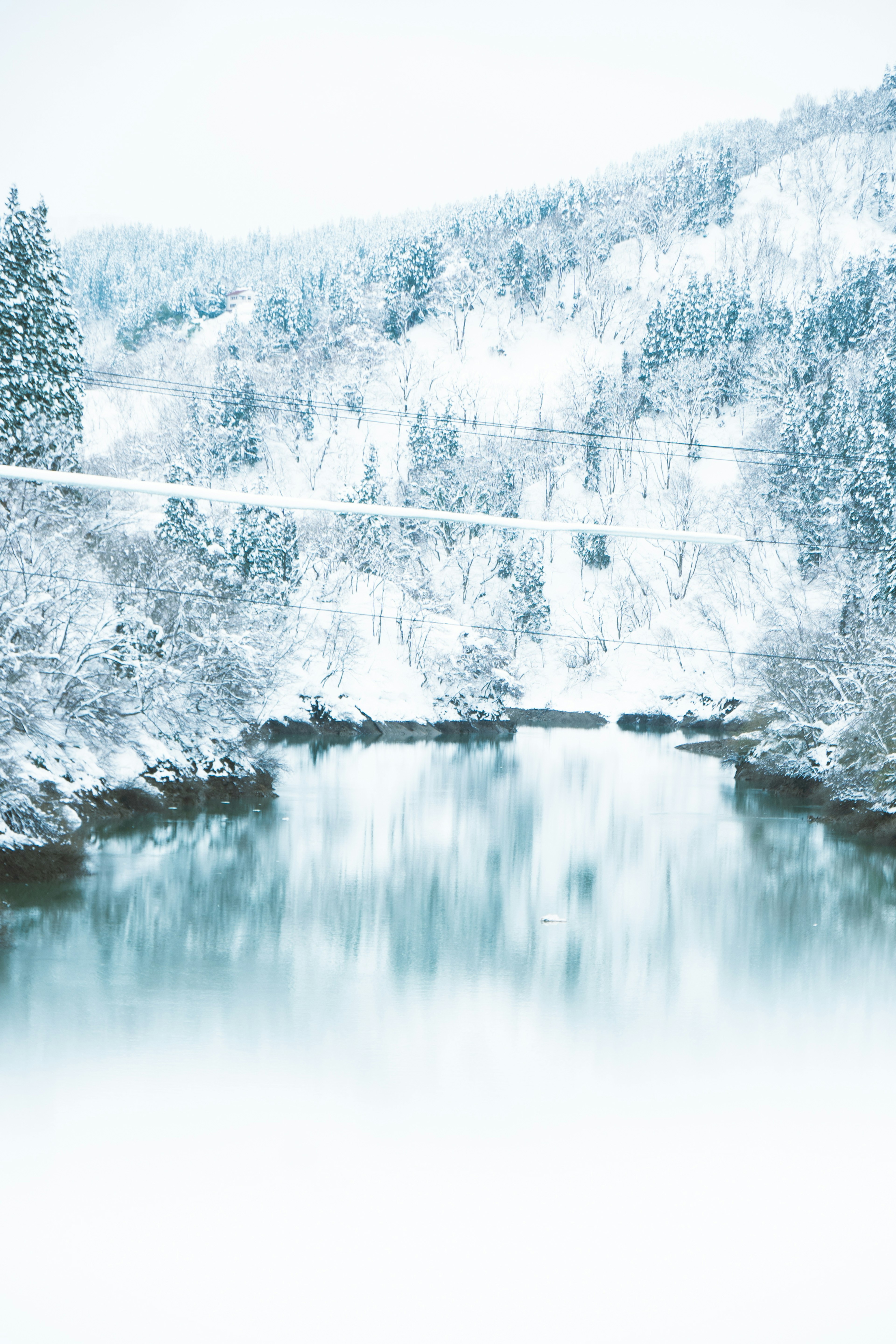 Snow-covered mountains and a tranquil river landscape