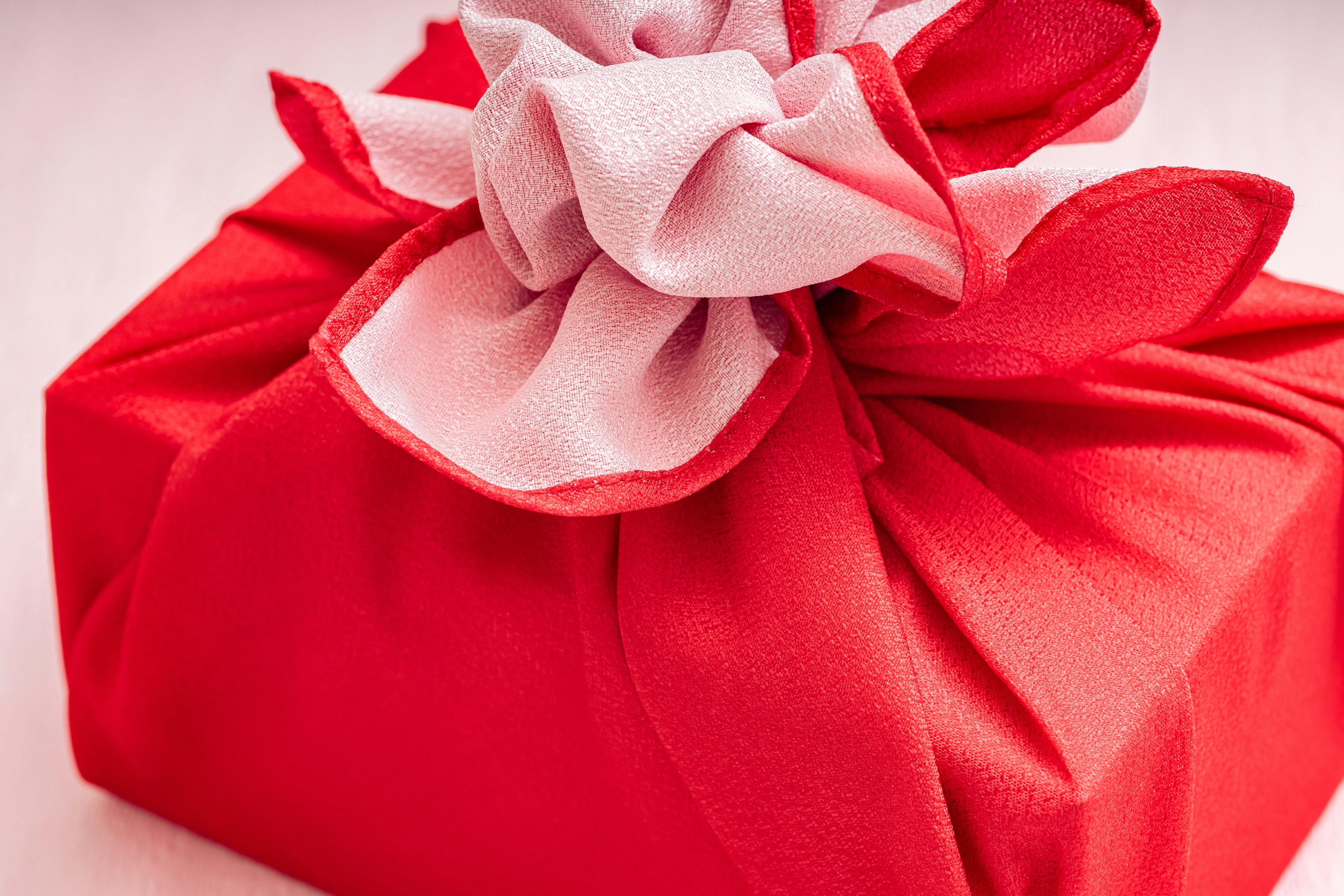 Red wrapped gift with white ribbon