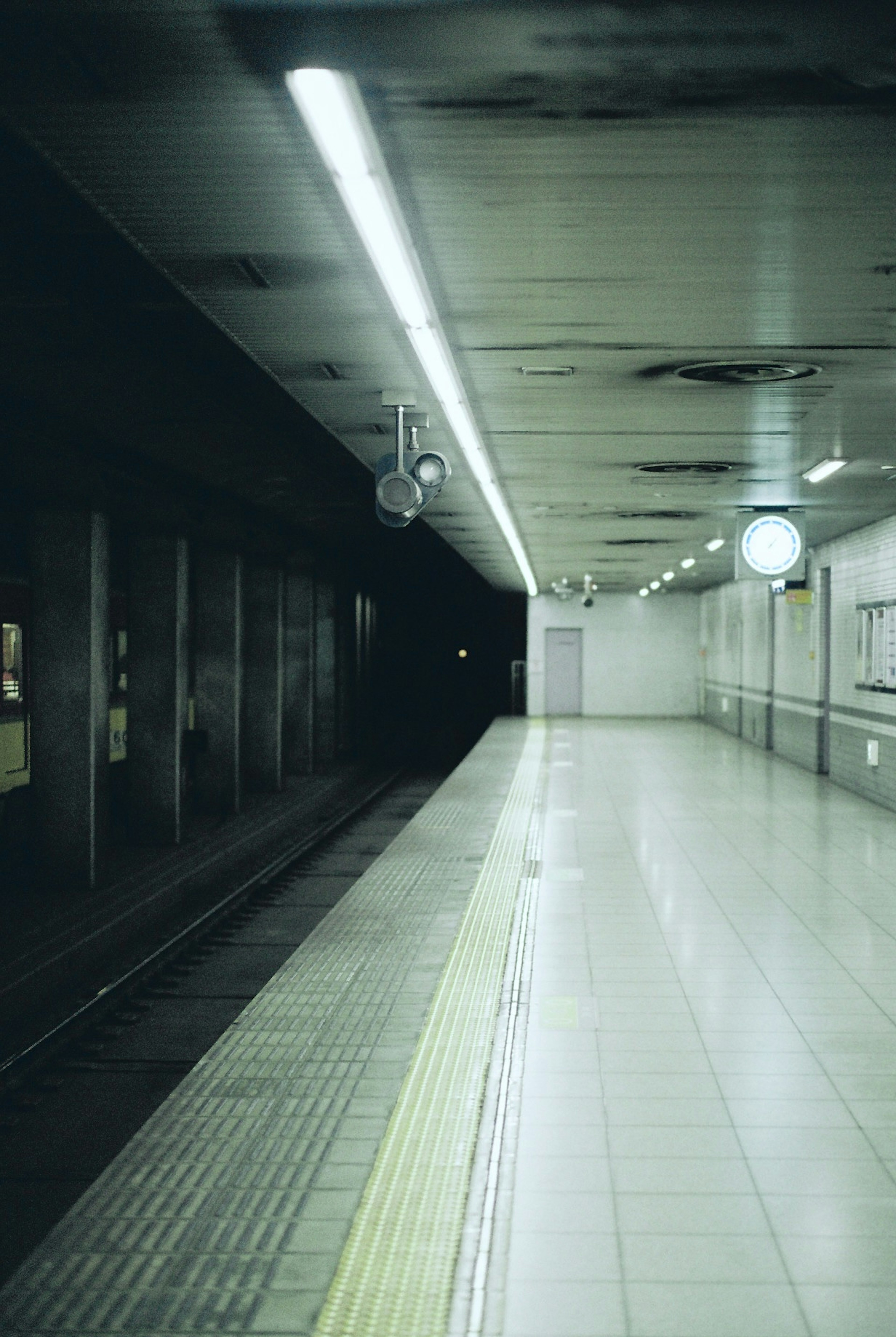 Piattaforma della metropolitana debolmente illuminata con orologio