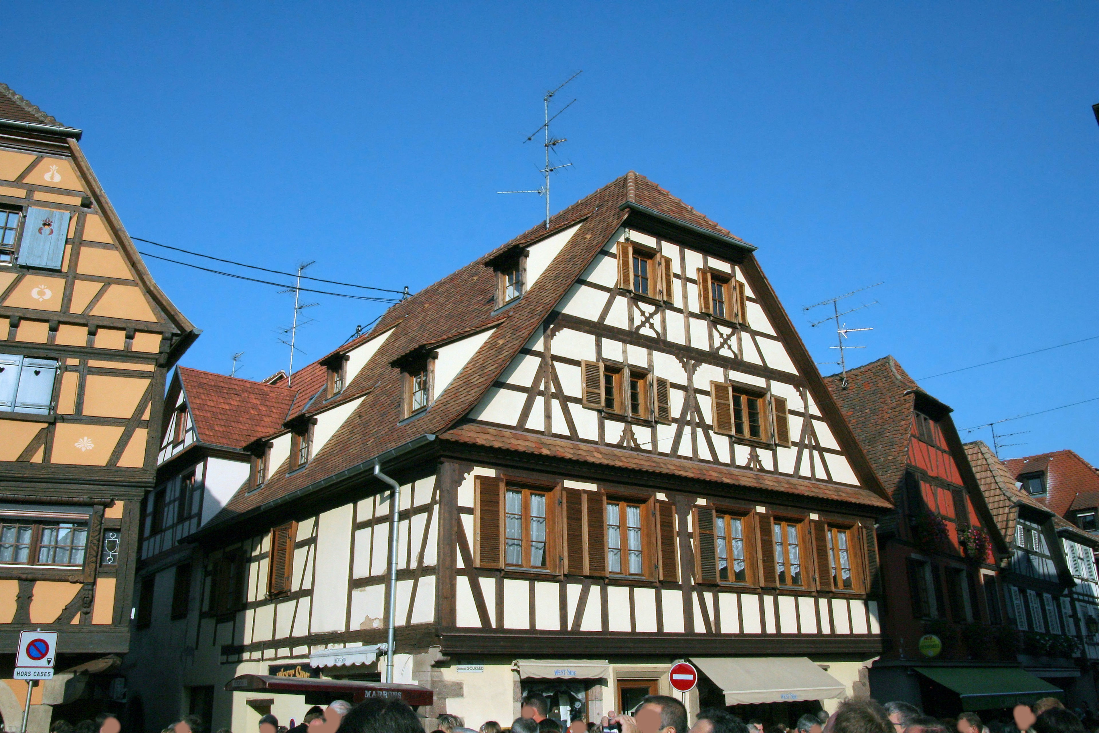 Traditional timber-framed house under a blue sky