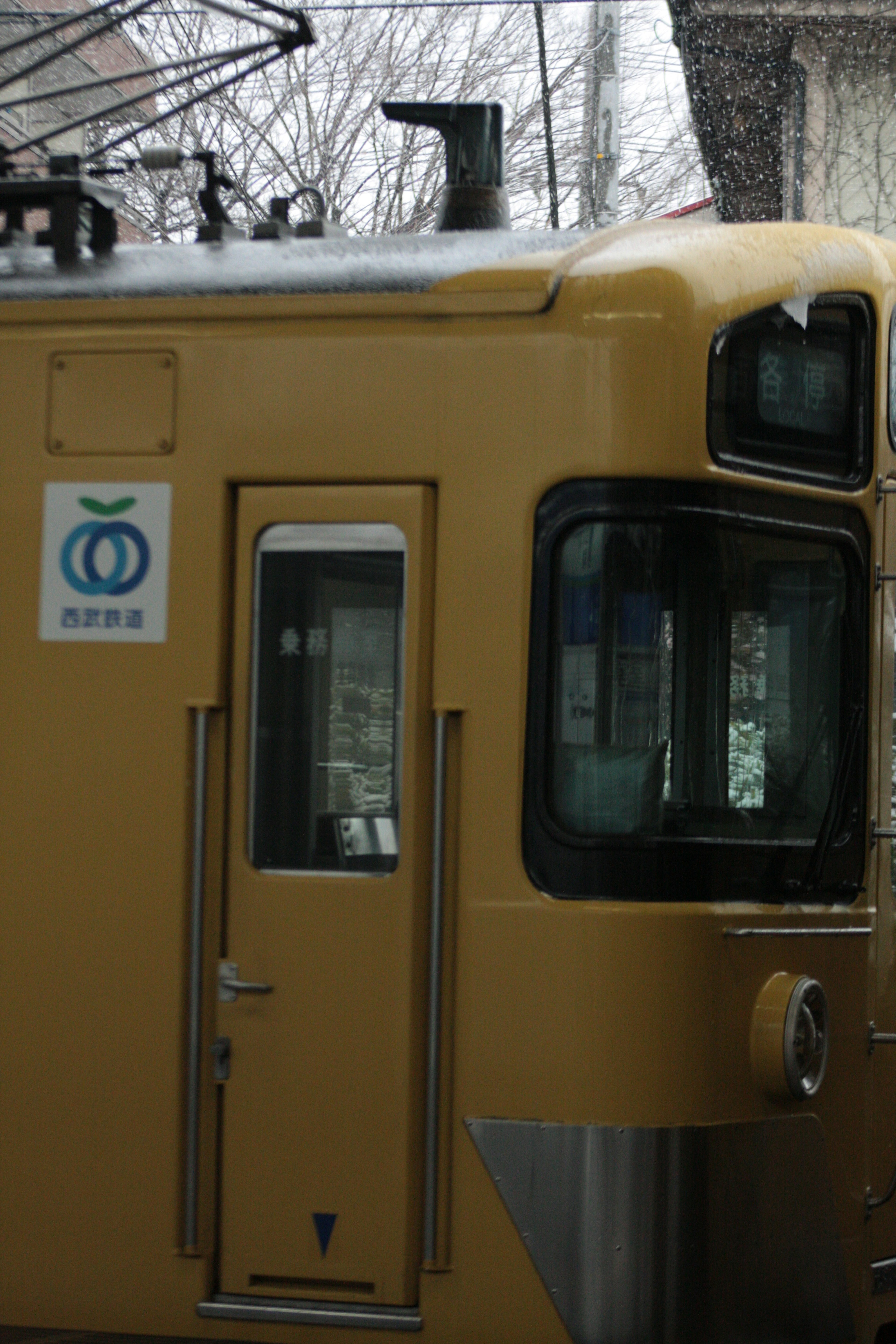 Detailed view of a yellow train with a window and door