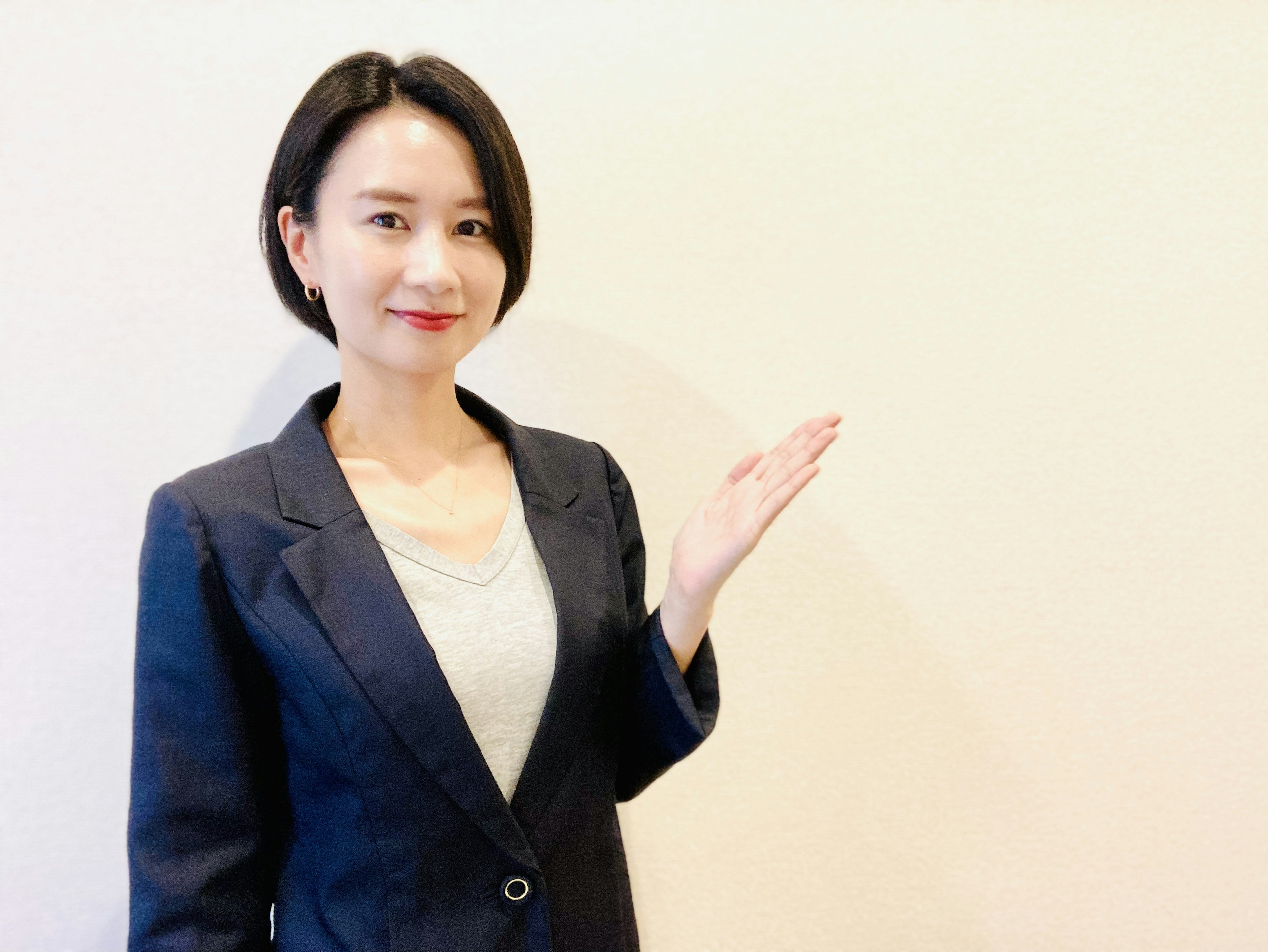 Woman in business attire gesturing with her hand