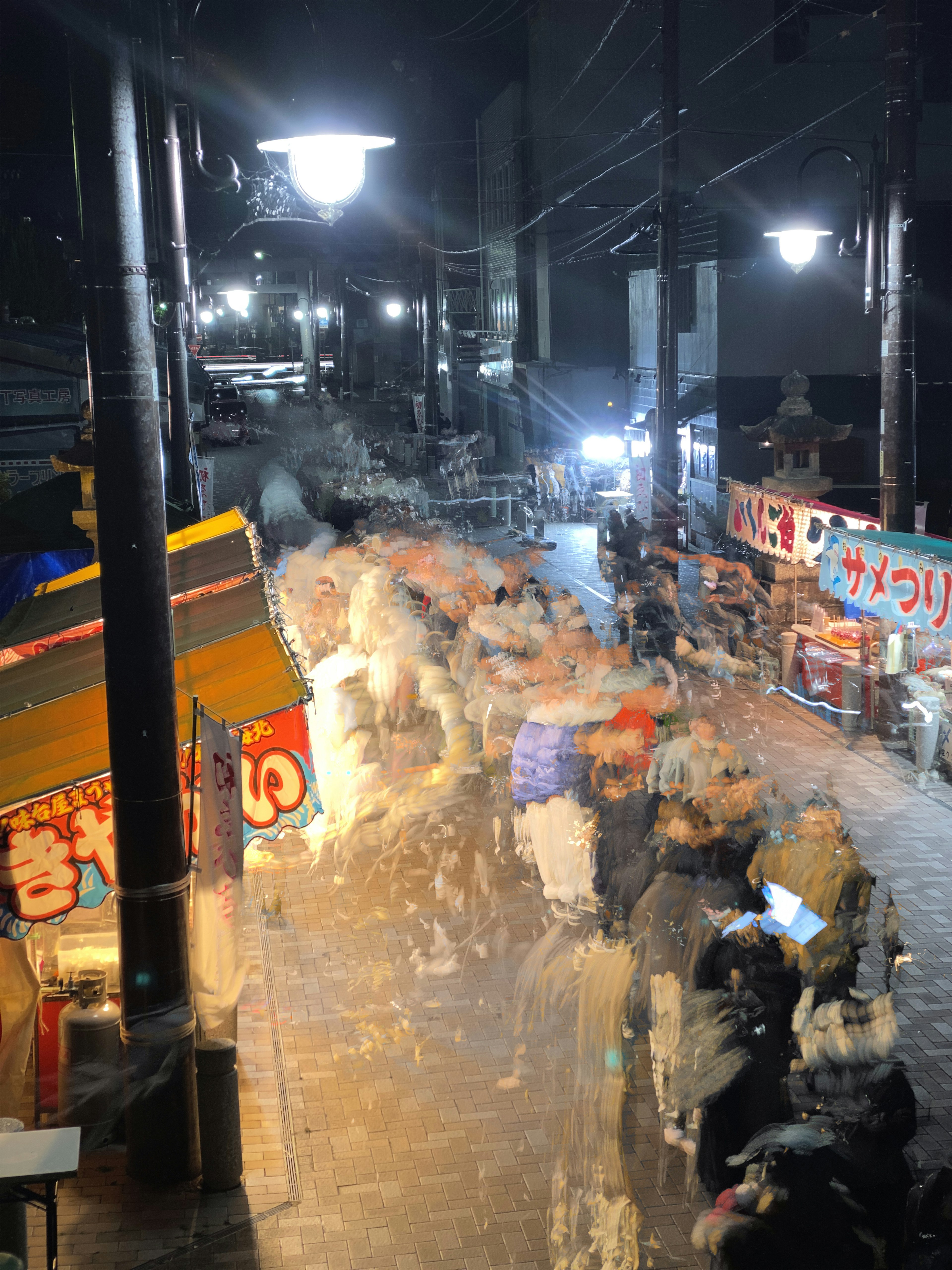 Vibrant street scene with food stalls at night