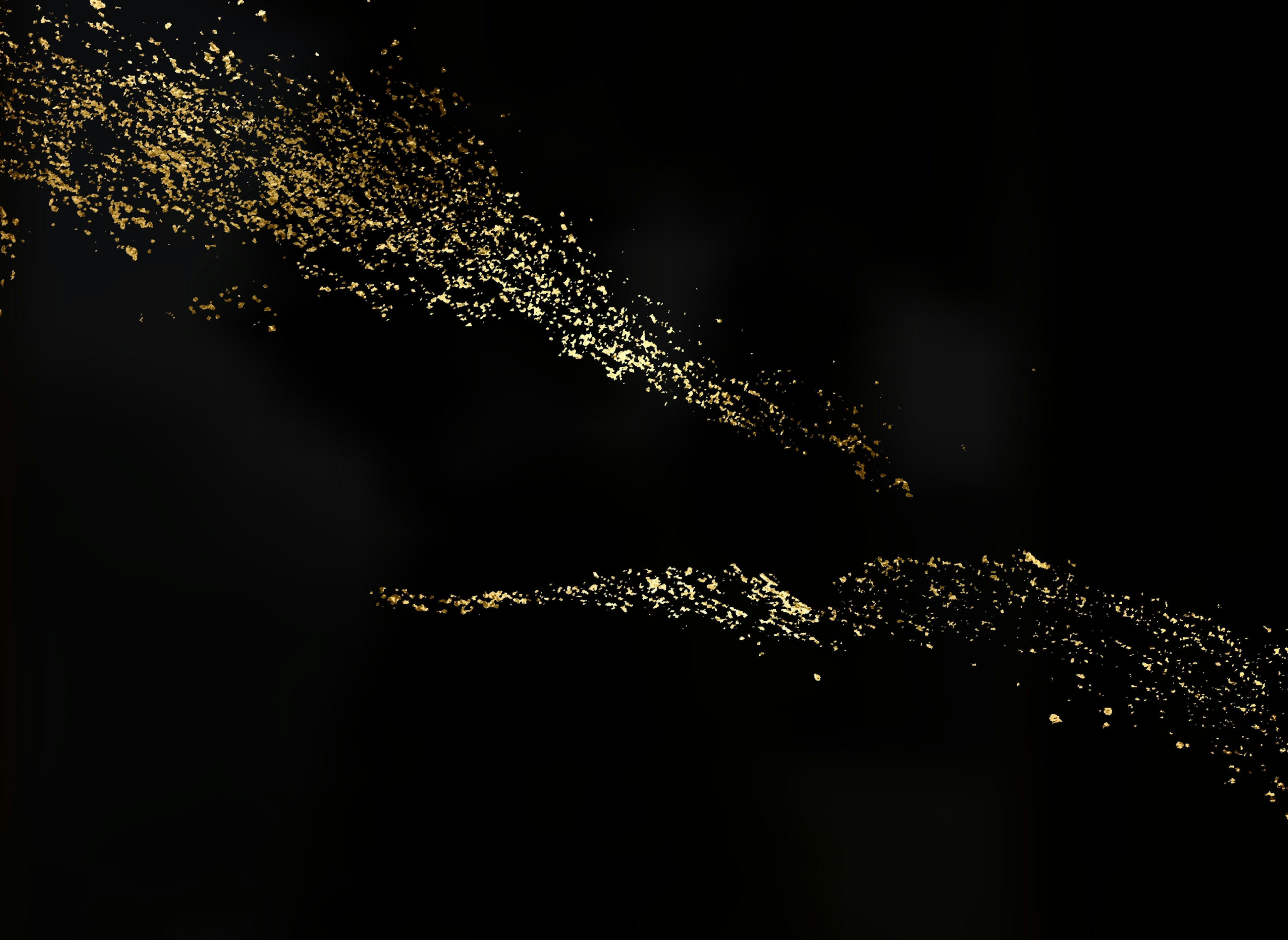 Beautiful pattern of golden particles scattered against a black background