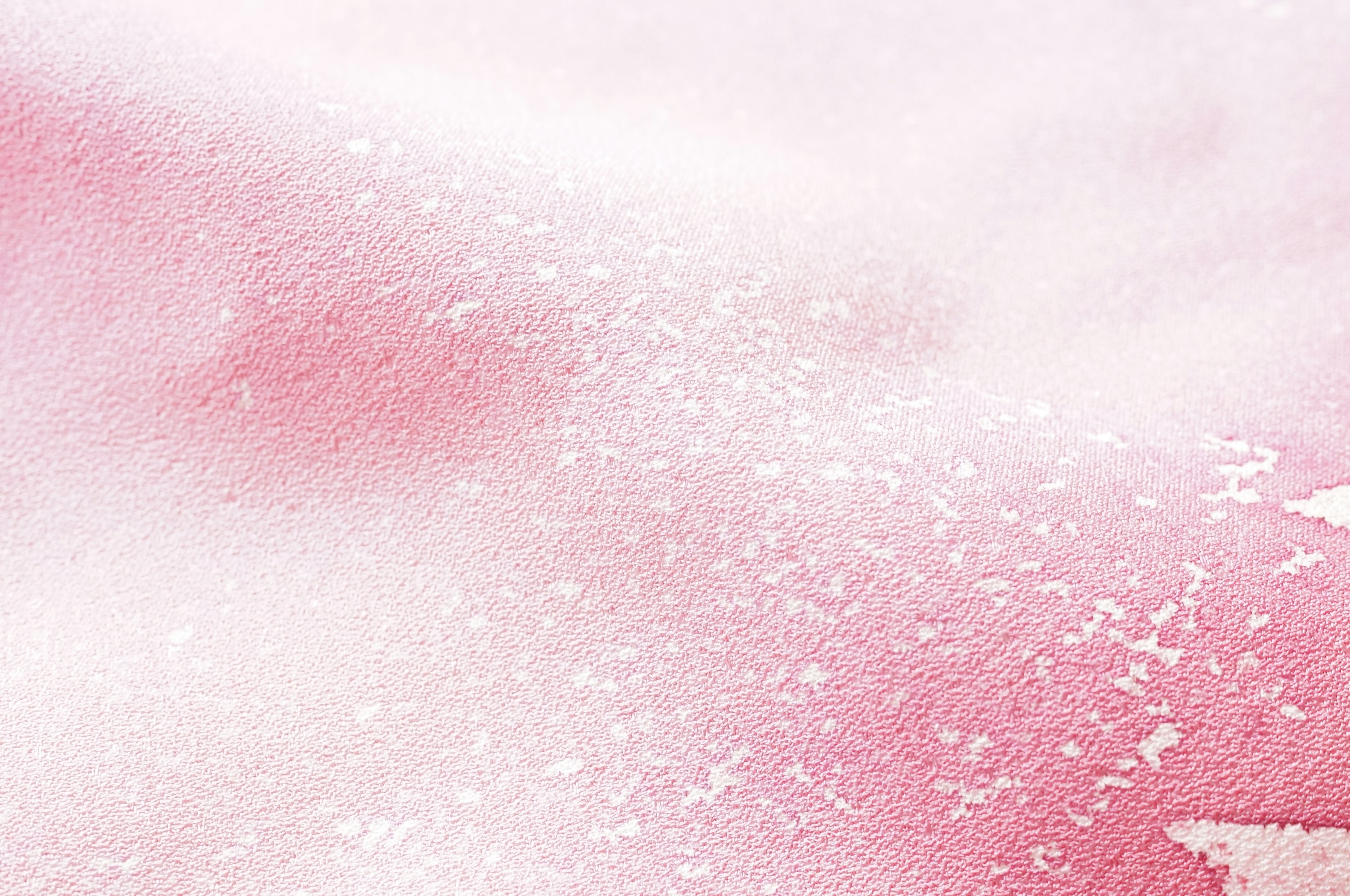 Soft pink watercolor background with scattered white speckles