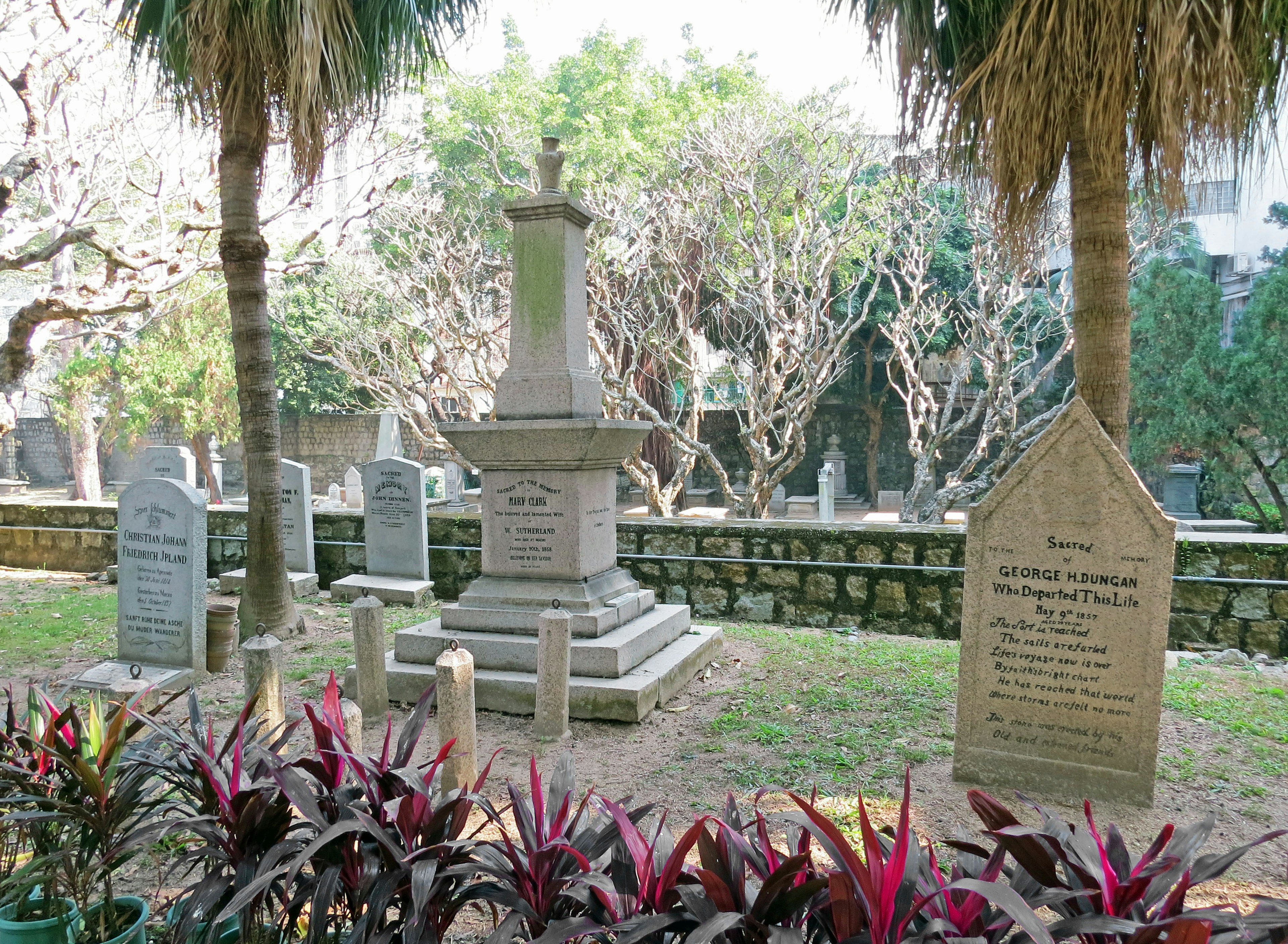 Graveyard scene with stone tombstones and green foliage