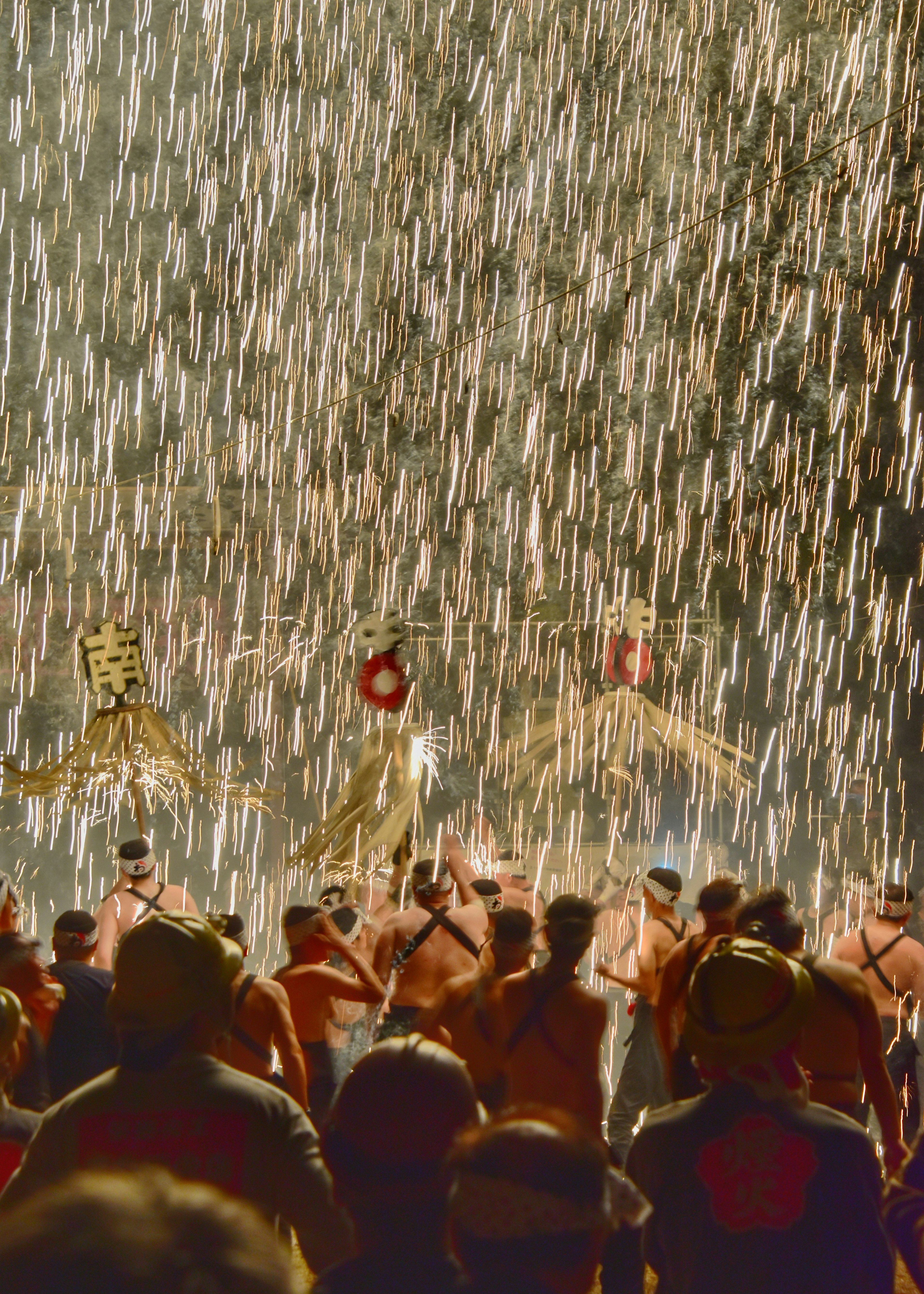 Festival participants dancing amidst a shower of sparks