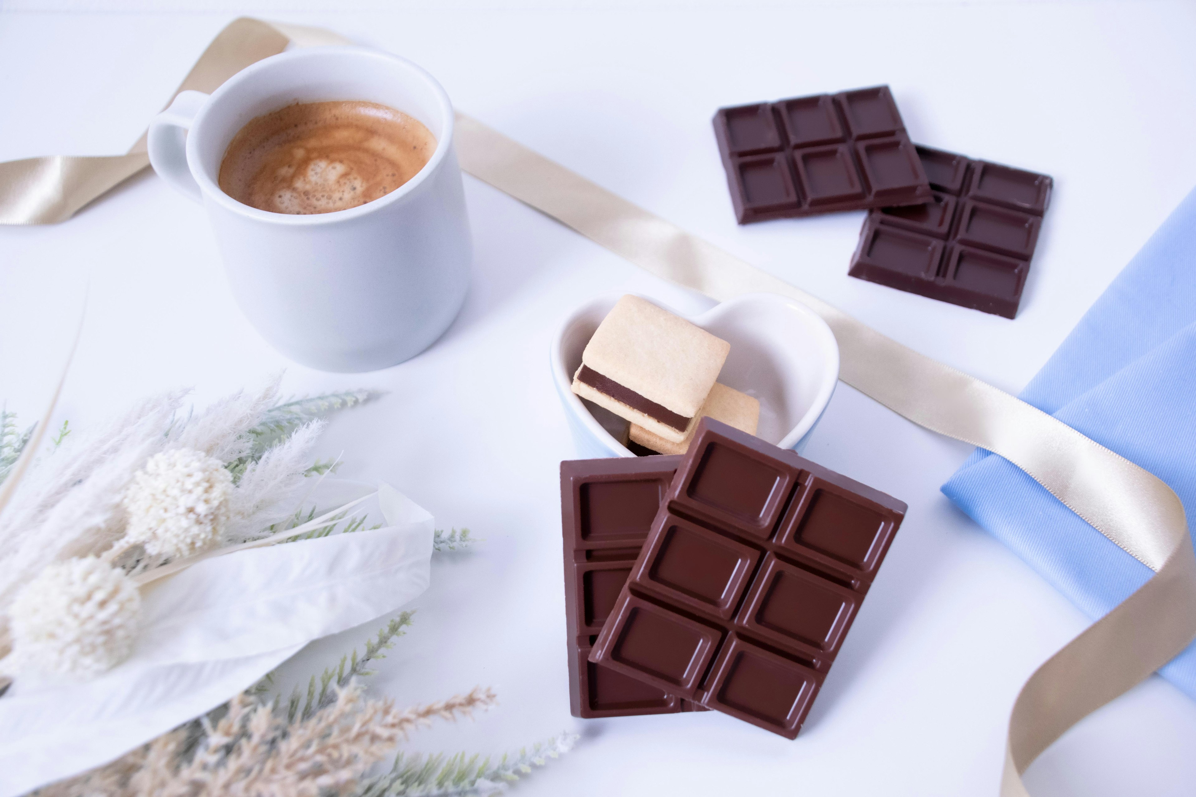 Serene table setting featuring coffee, chocolate, and decorative elements