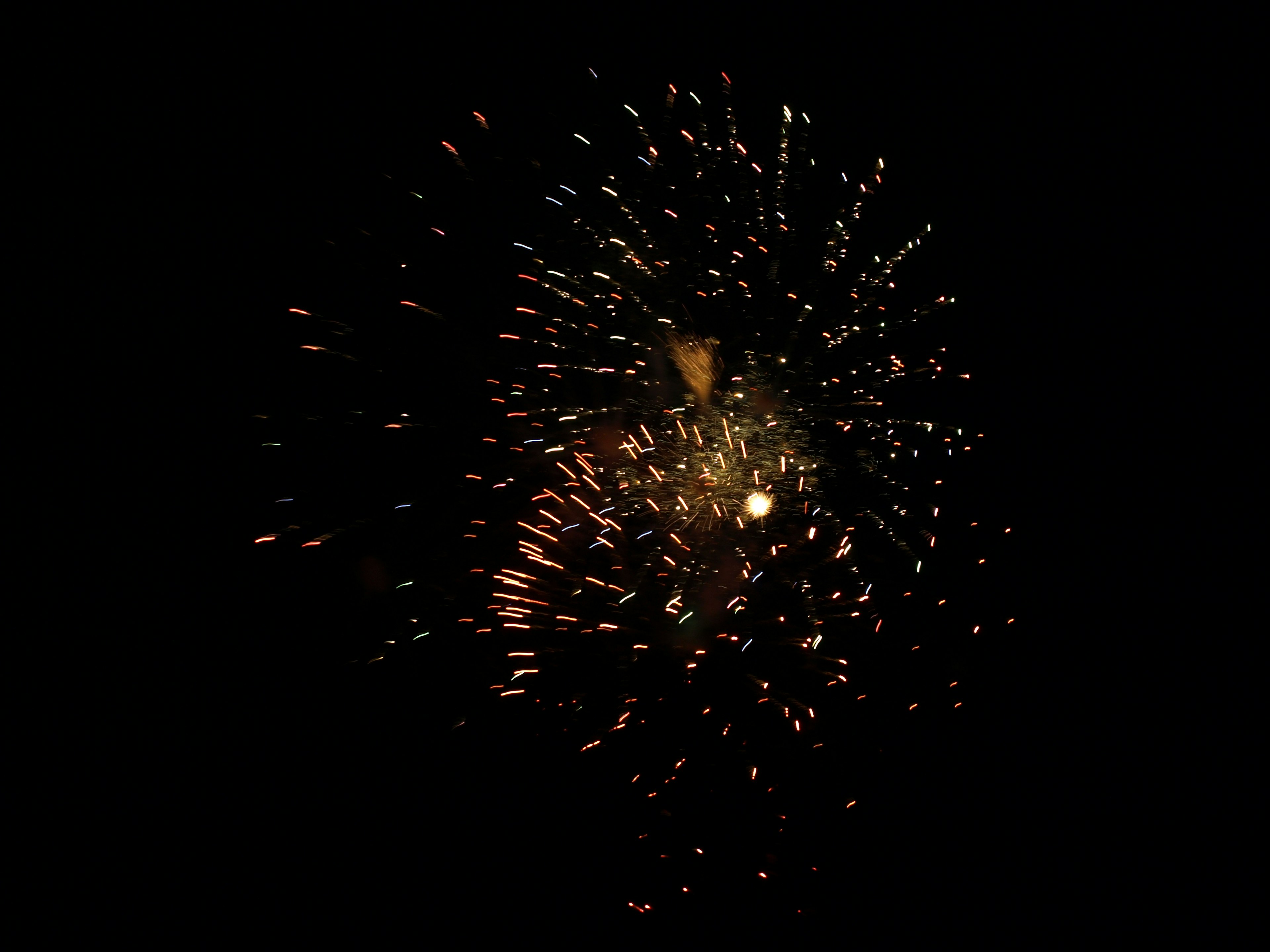 Explosion of fireworks against a black background