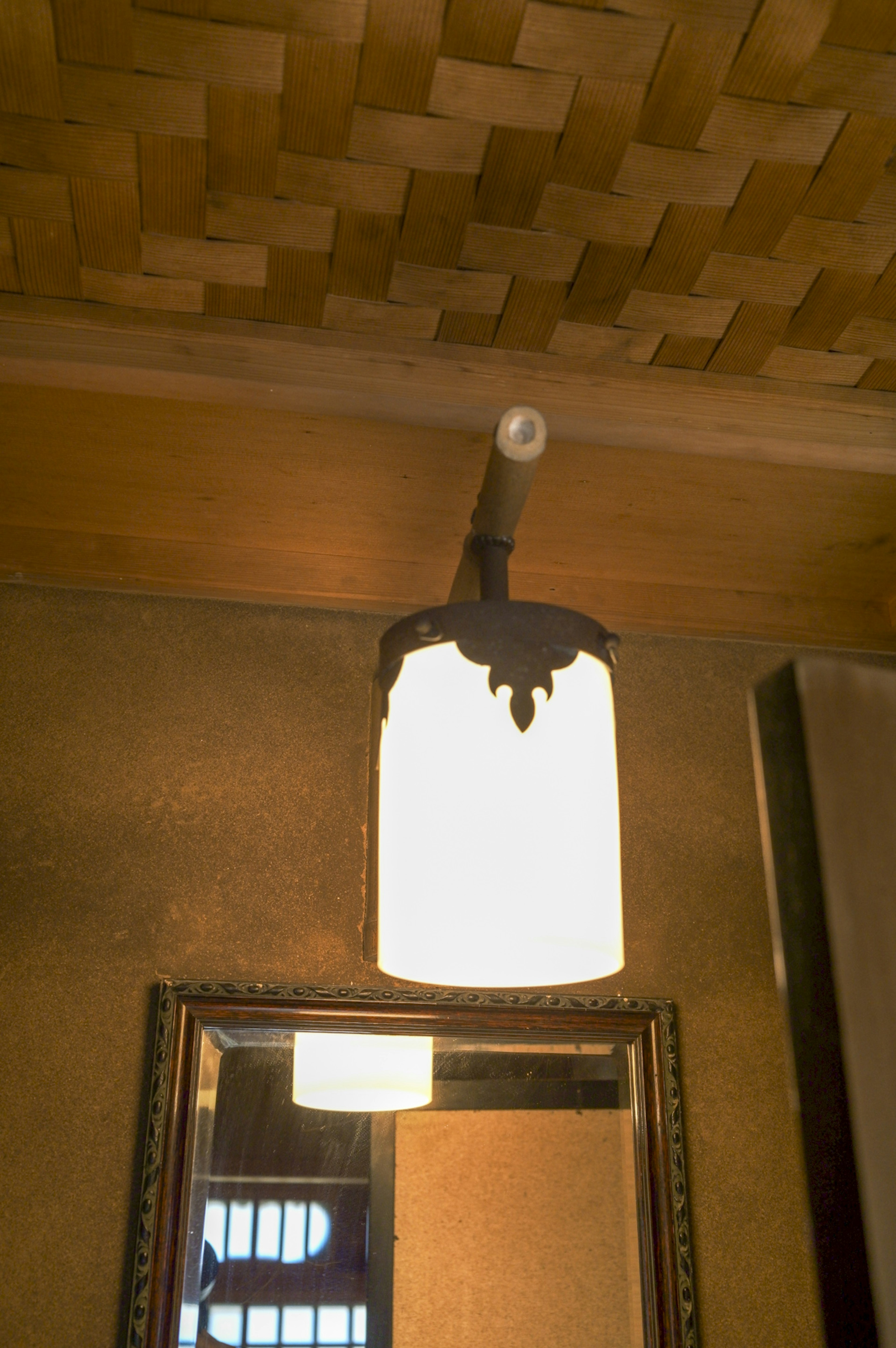 Unique ceiling-mounted light fixture with a mirror reflection