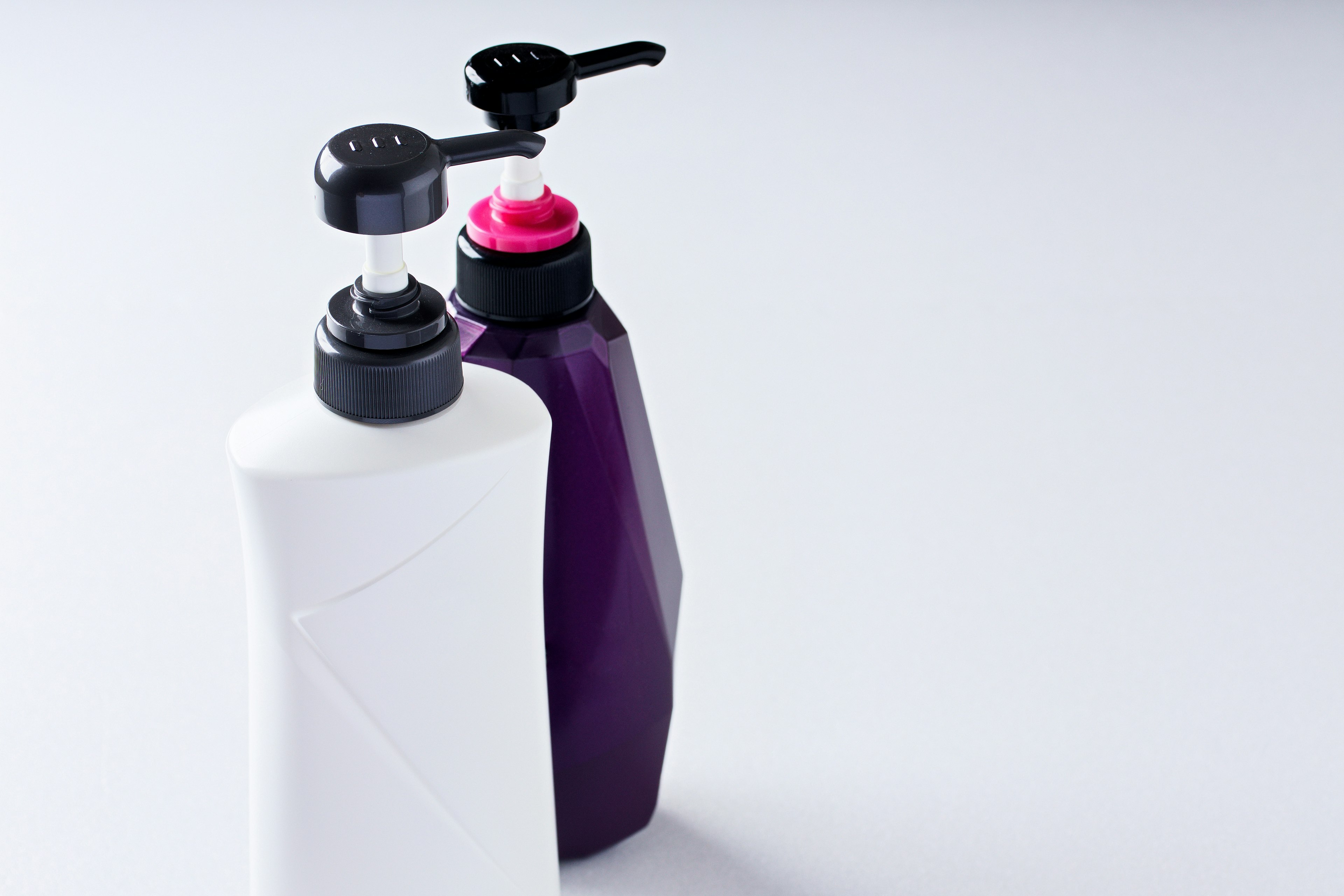 Simple design featuring a white and purple bottle side by side