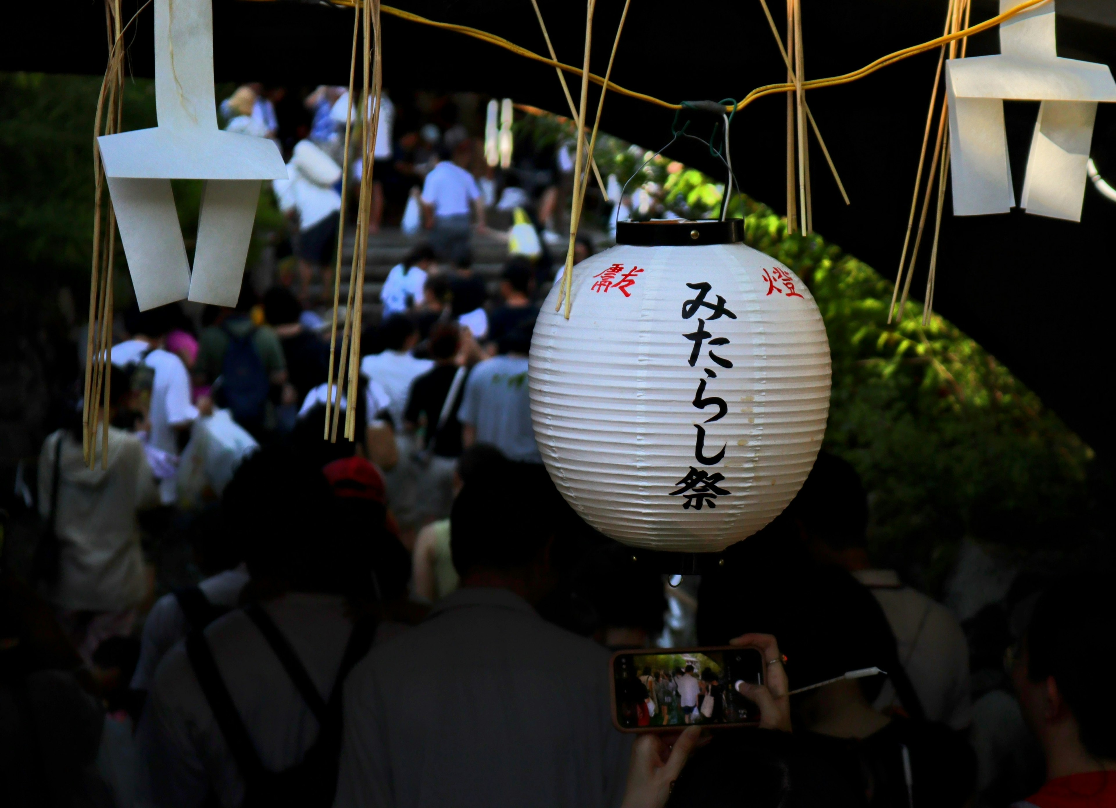 Scene of a festival lantern hanging with people gathering