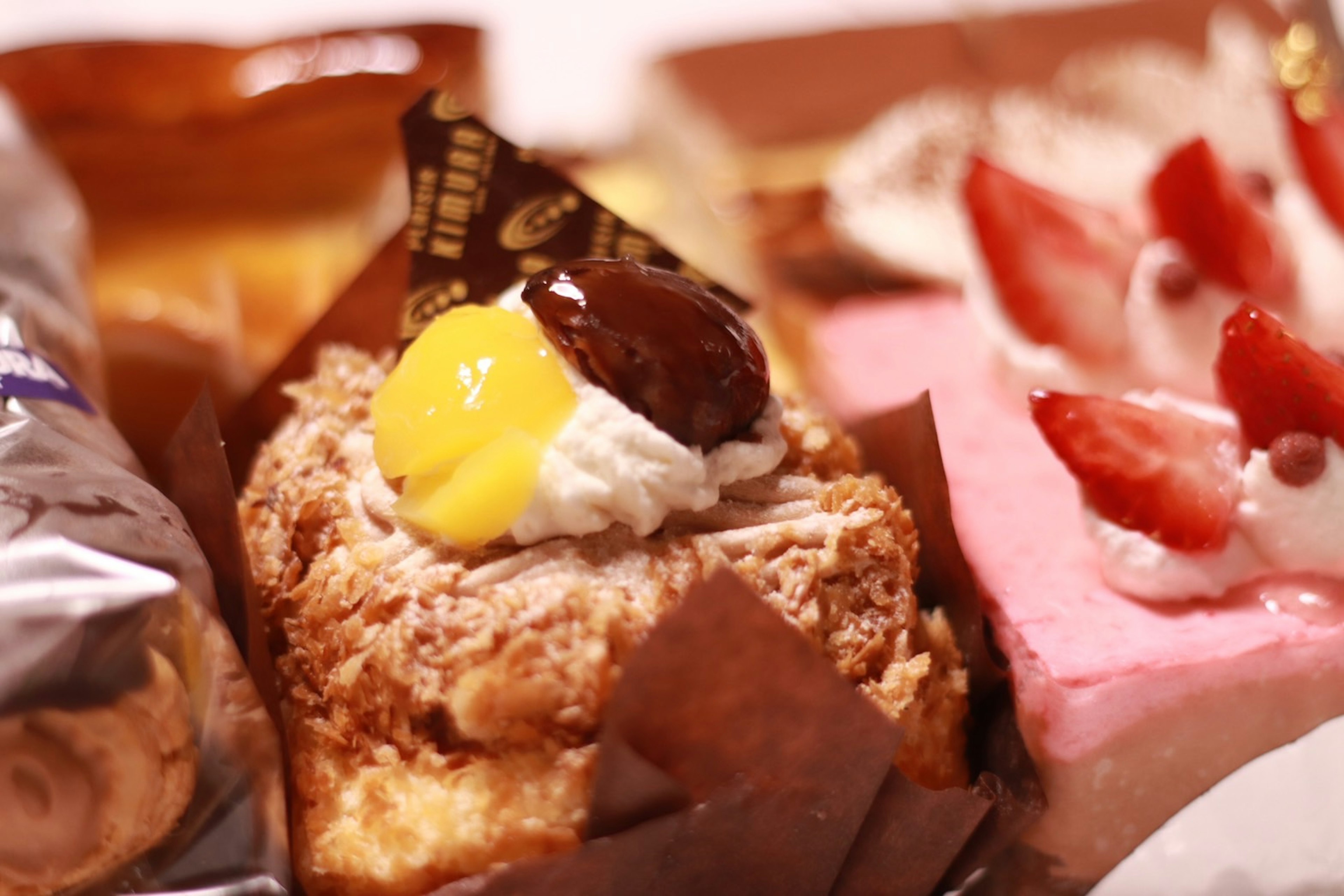 A colorful assortment of cakes featuring cream and fruit toppings