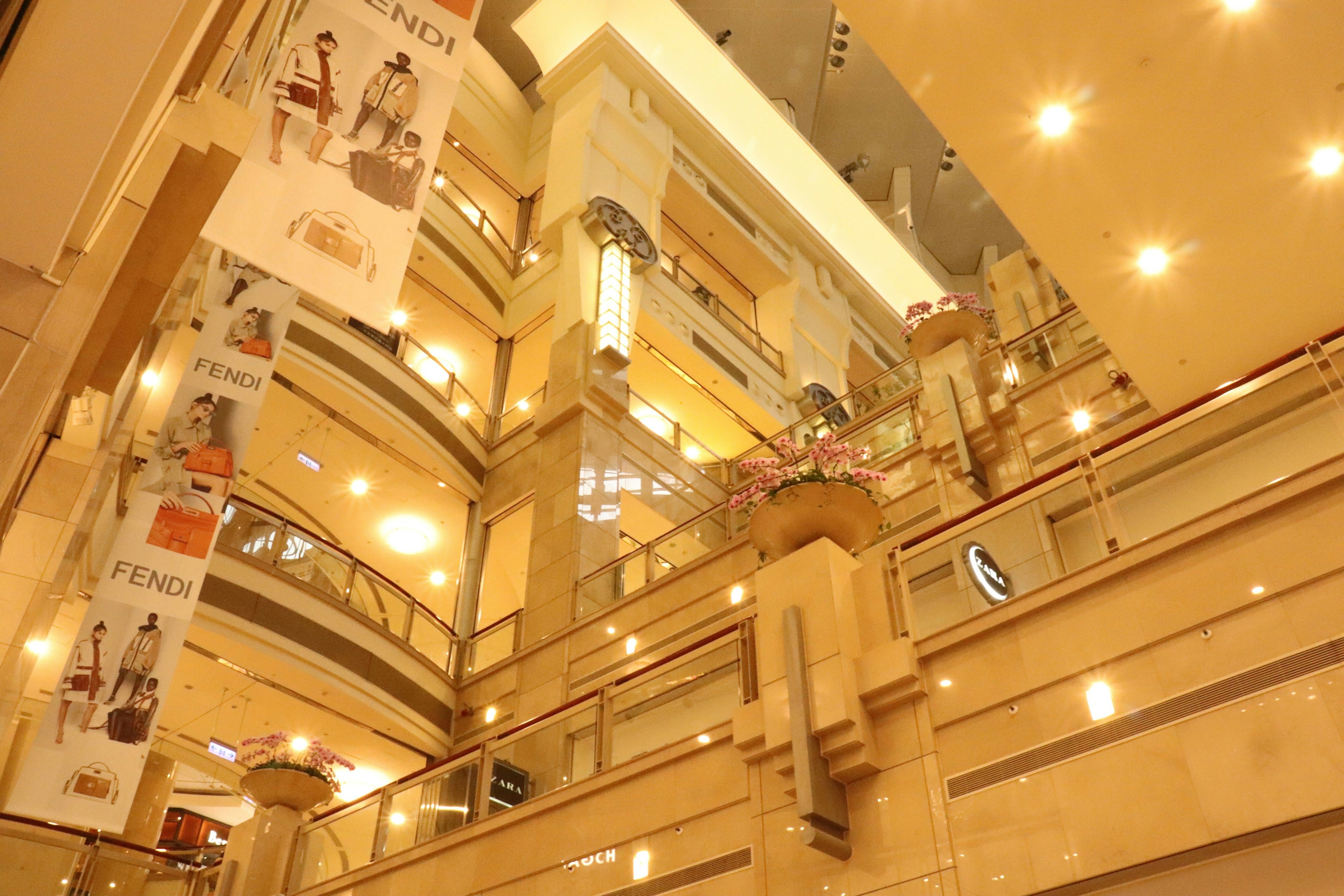 Interior of a luxury commercial building with bright lighting and decorative banners