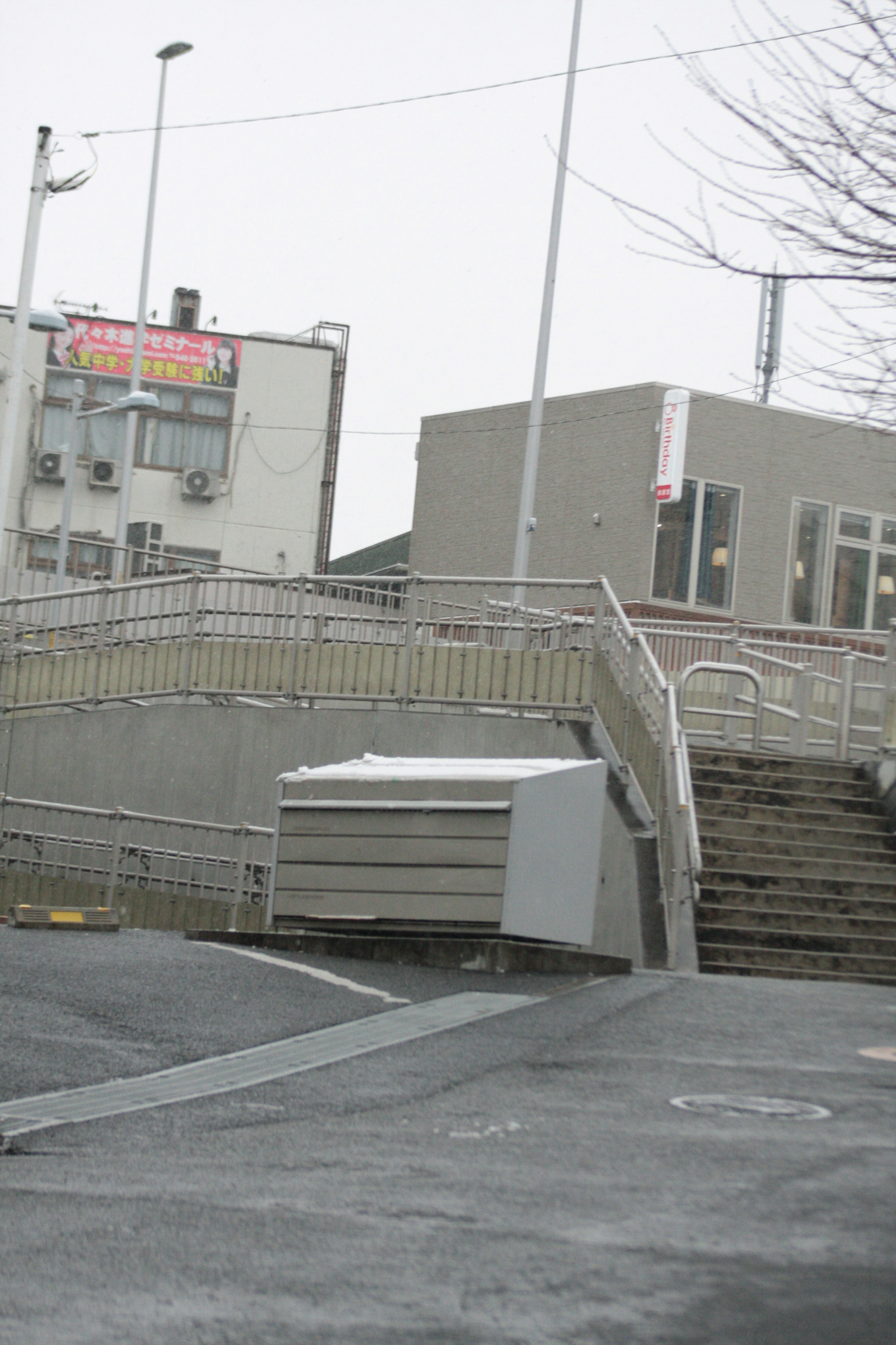 Urban scene featuring a ramp and stairs leading to a building