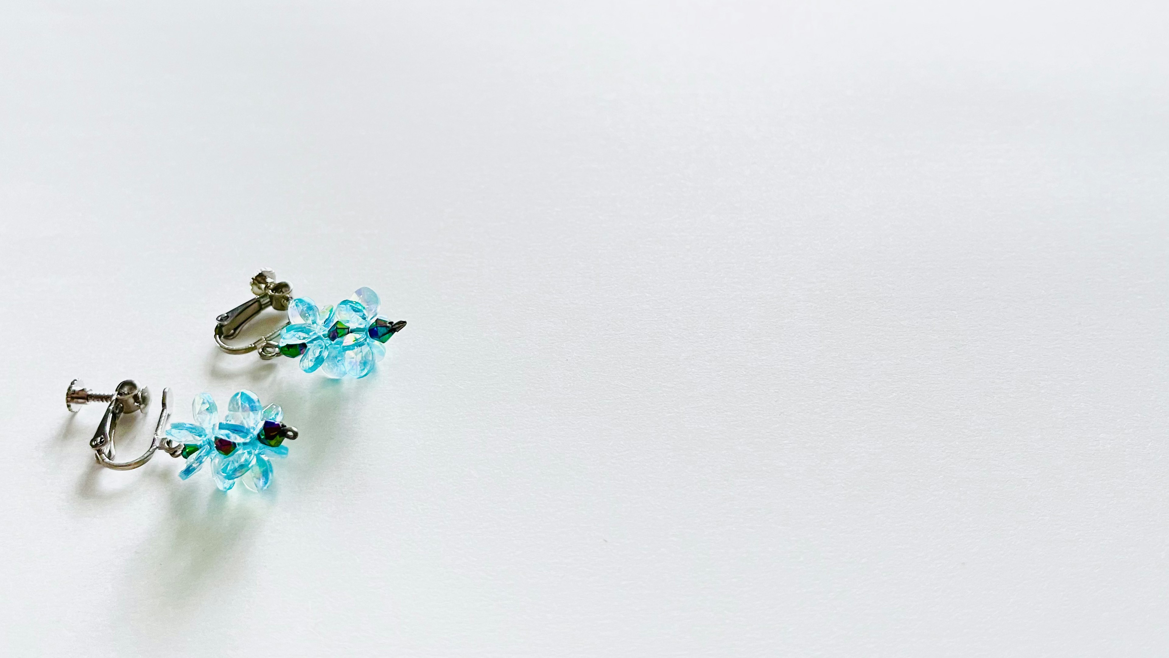 Blue gemstone earrings placed on a white background