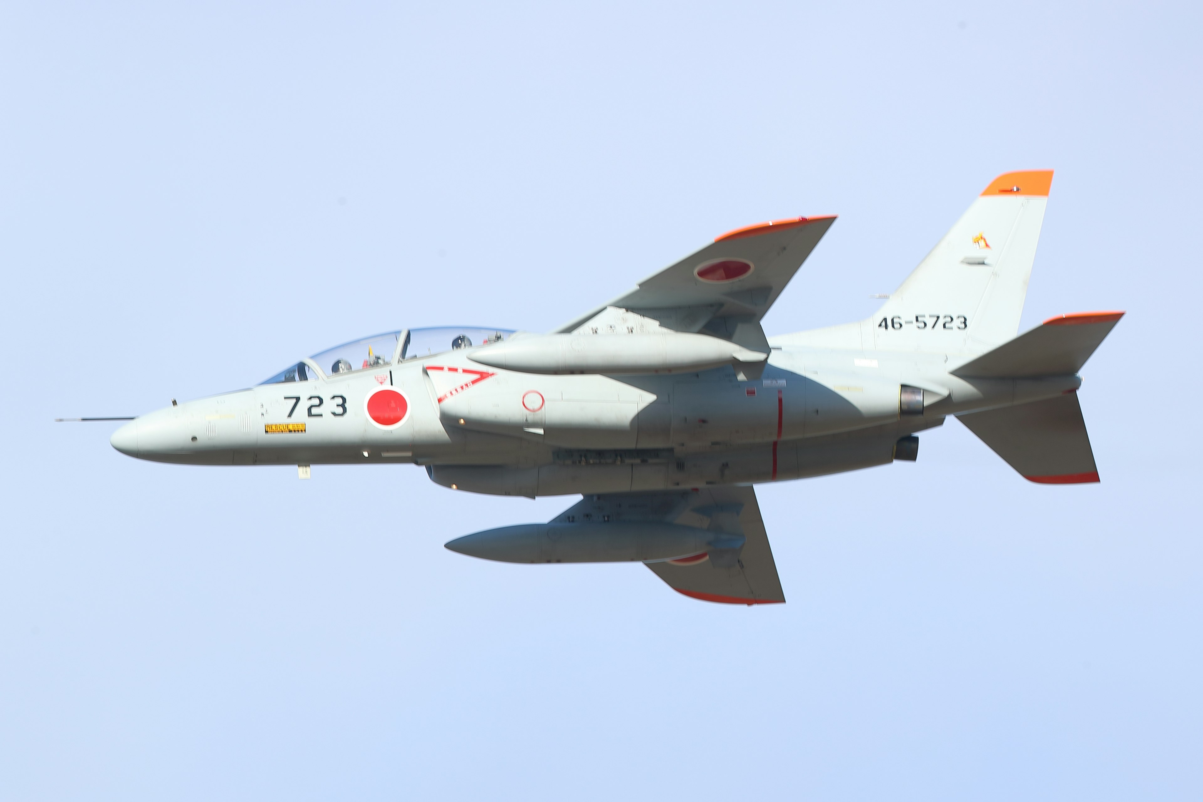 Japanese military jet flying against a clear sky