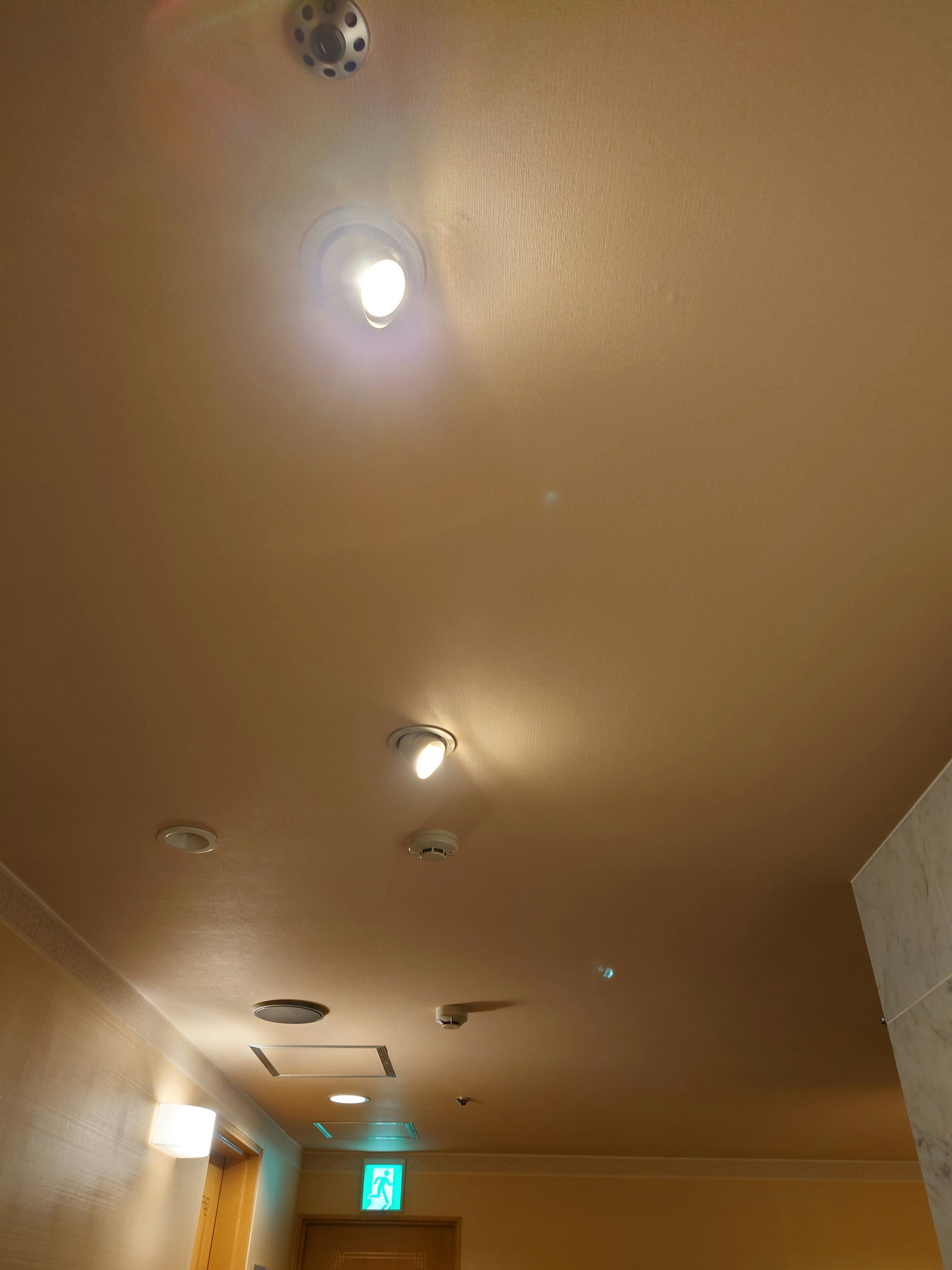 Image of a brightly lit hallway ceiling with various lights