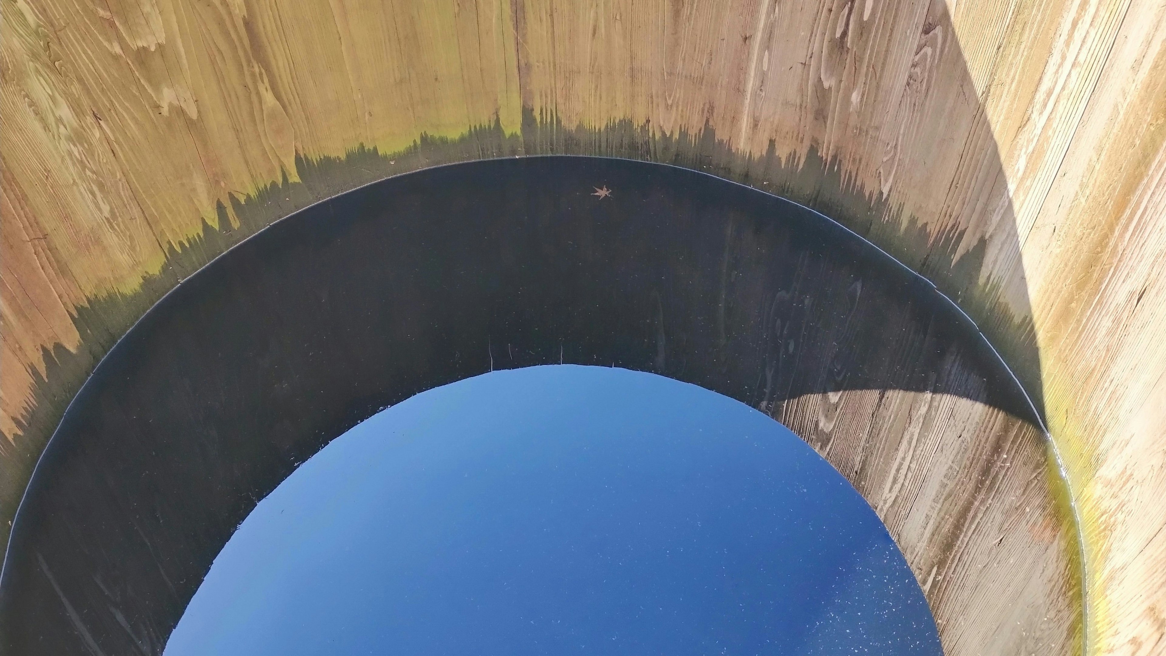 View of a blue sky from inside a circular structure