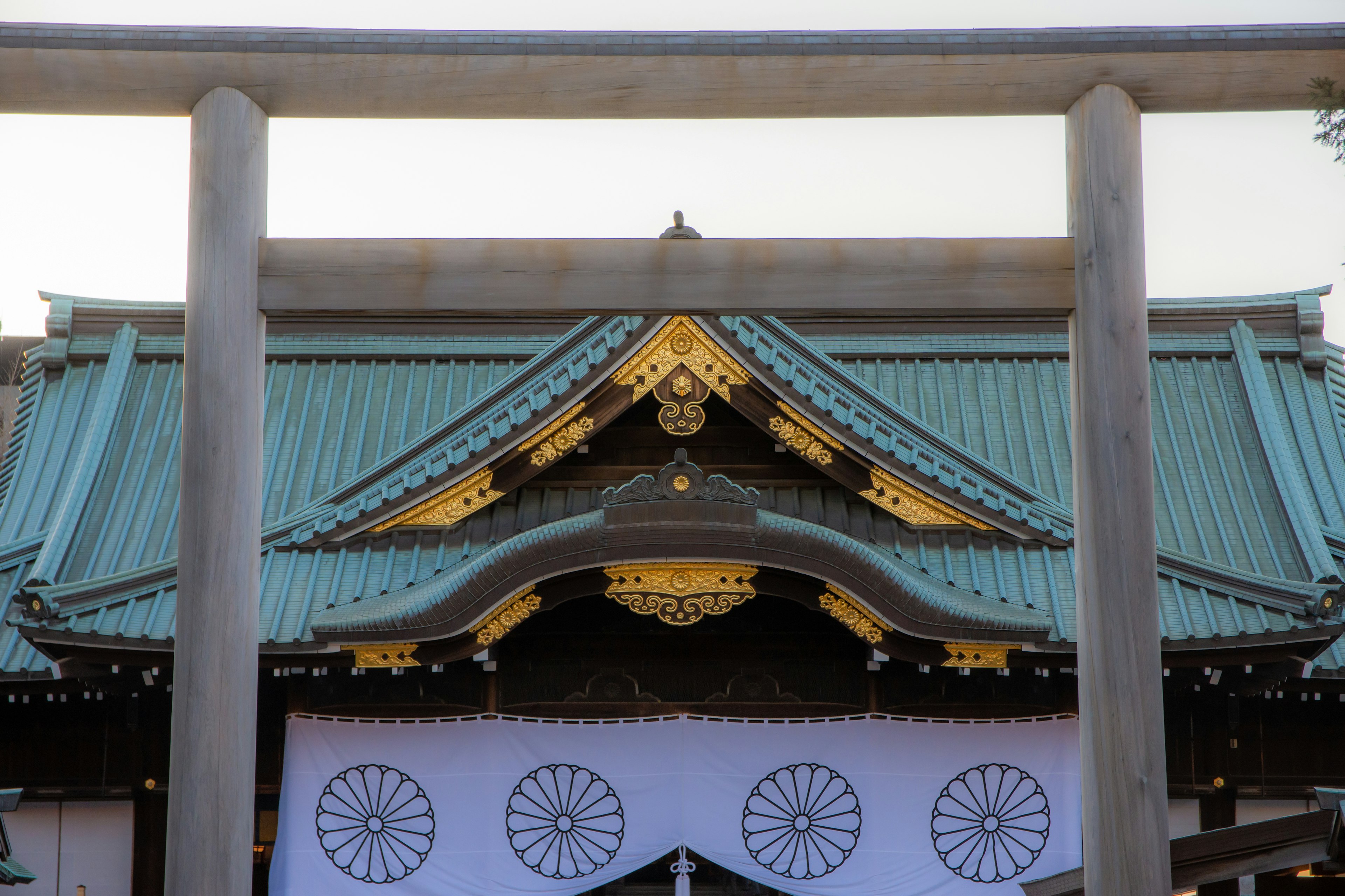 Entrance of a shrine with a blue roof and golden decorations