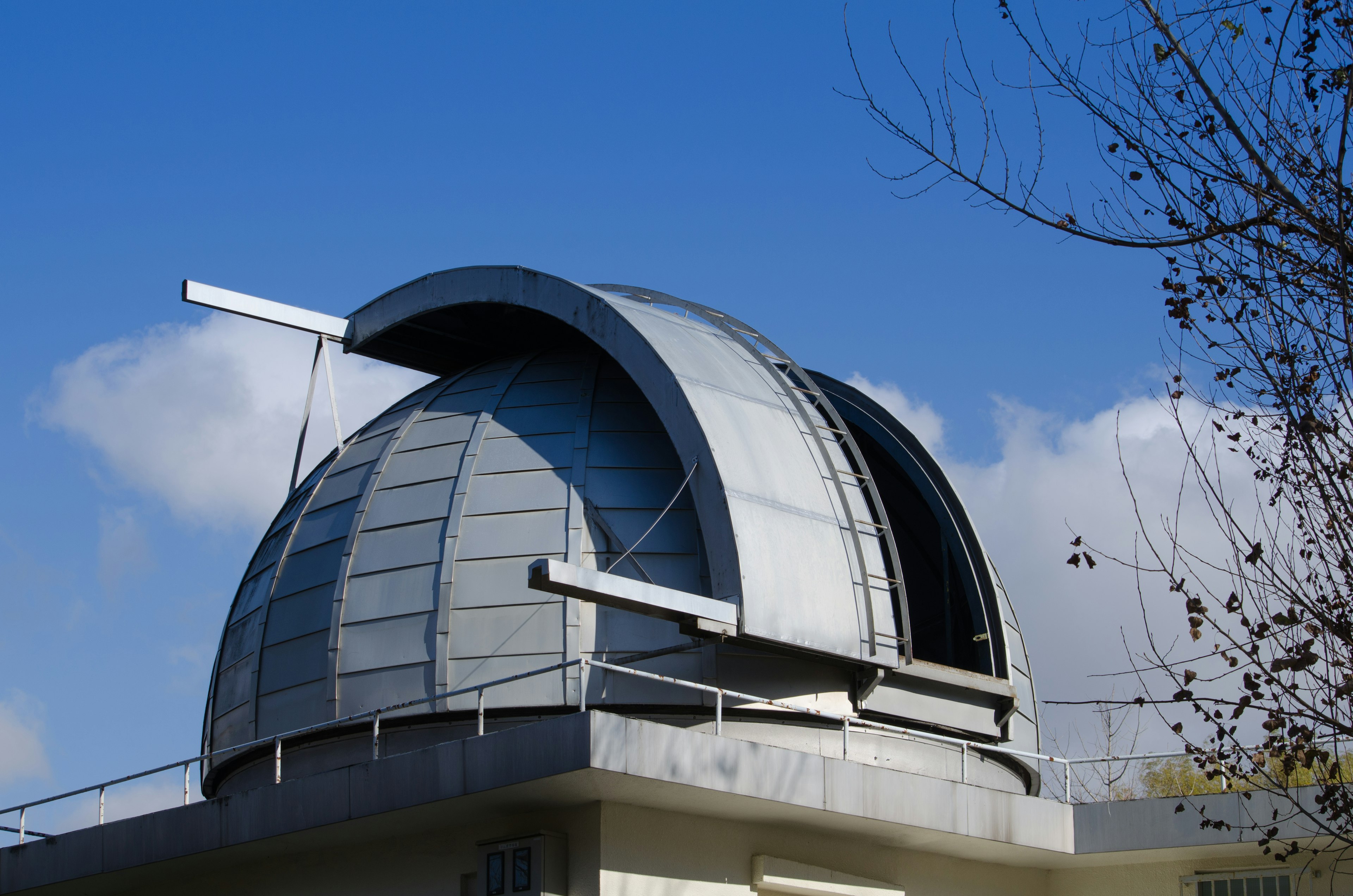 Modern observatory dome under a blue sky