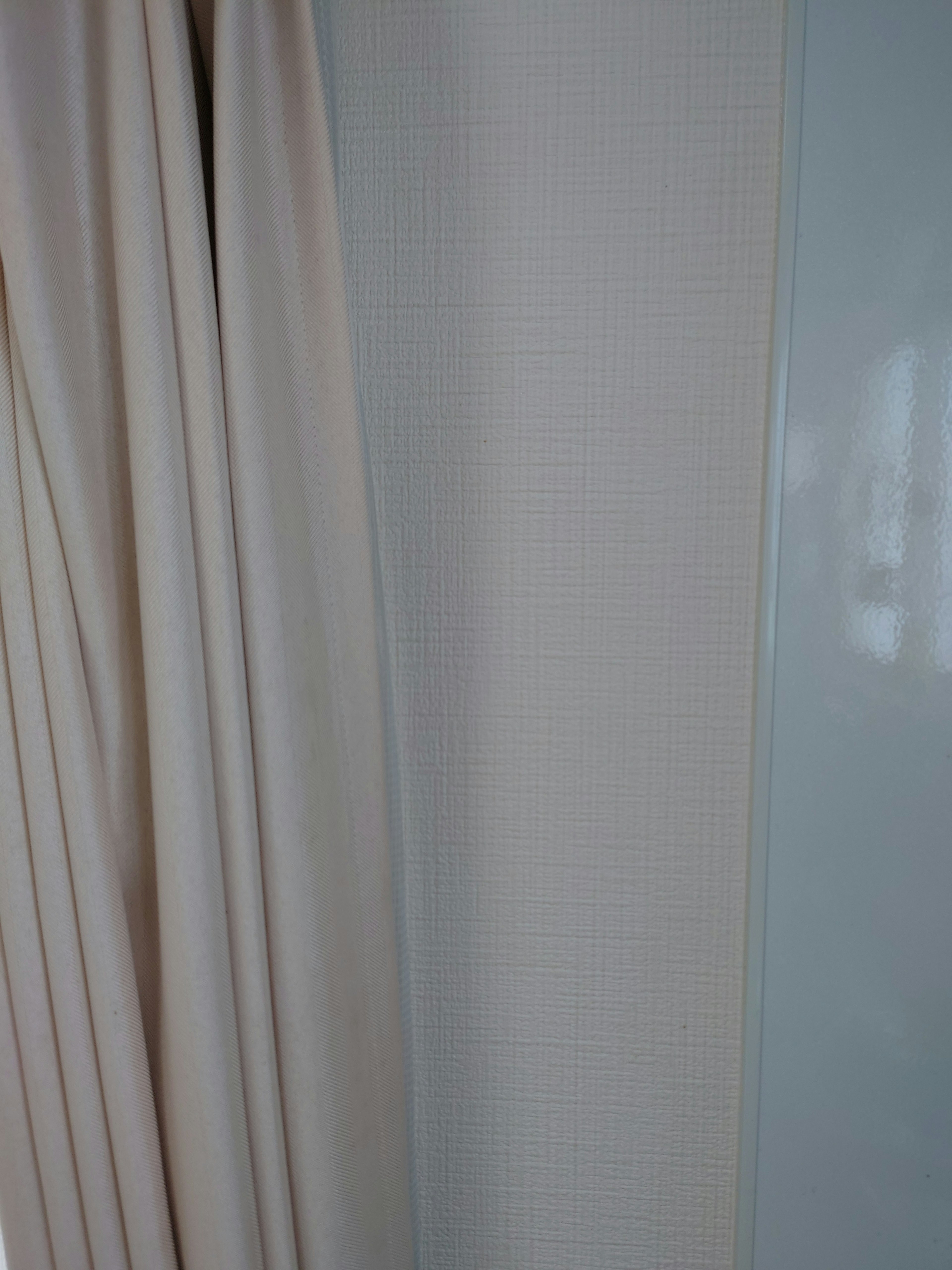 Close-up shot of light curtain and glossy wall