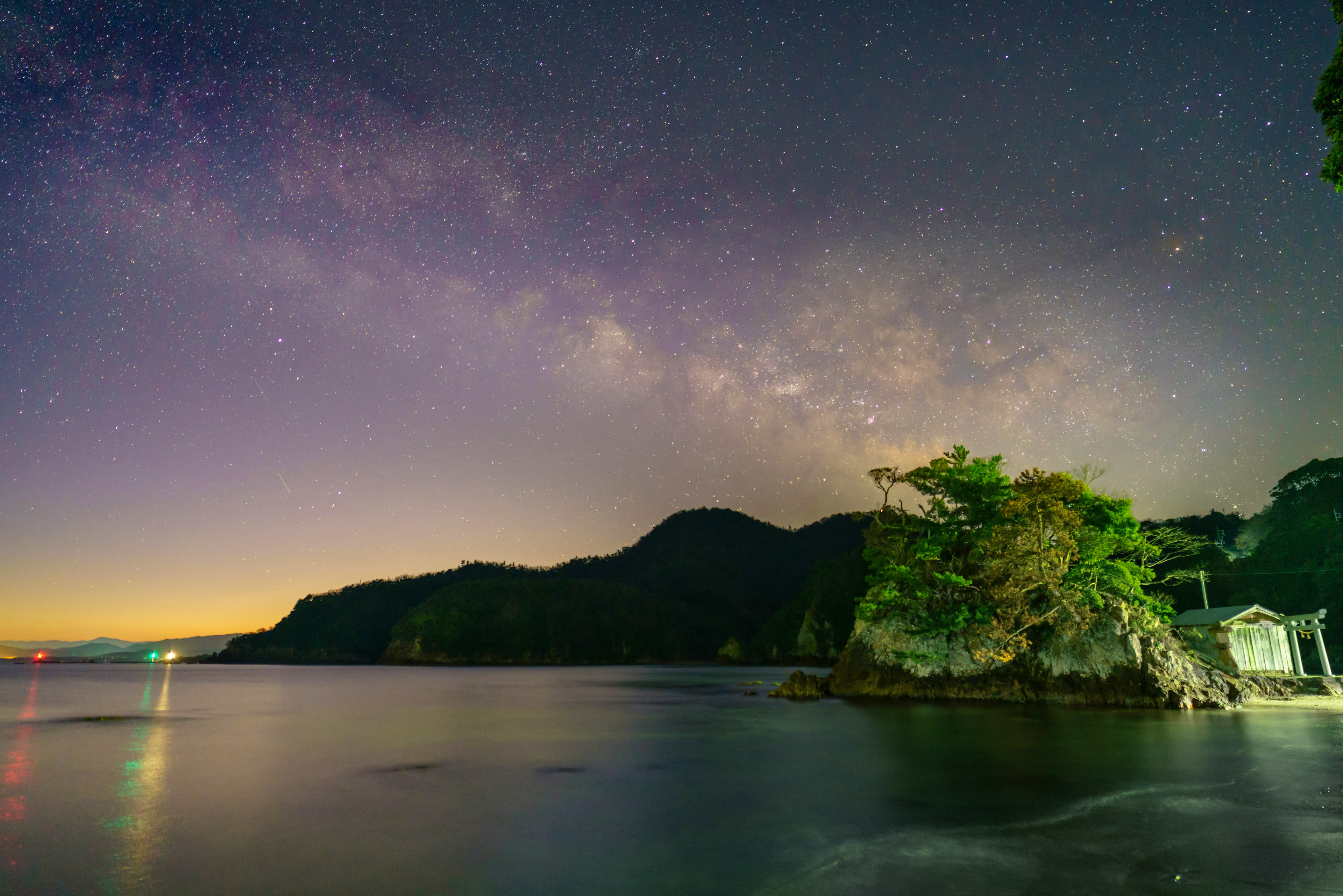 美しい夜空に広がる天の川と静かな海の風景 雄大な山々と緑に覆われた小島が特徴的