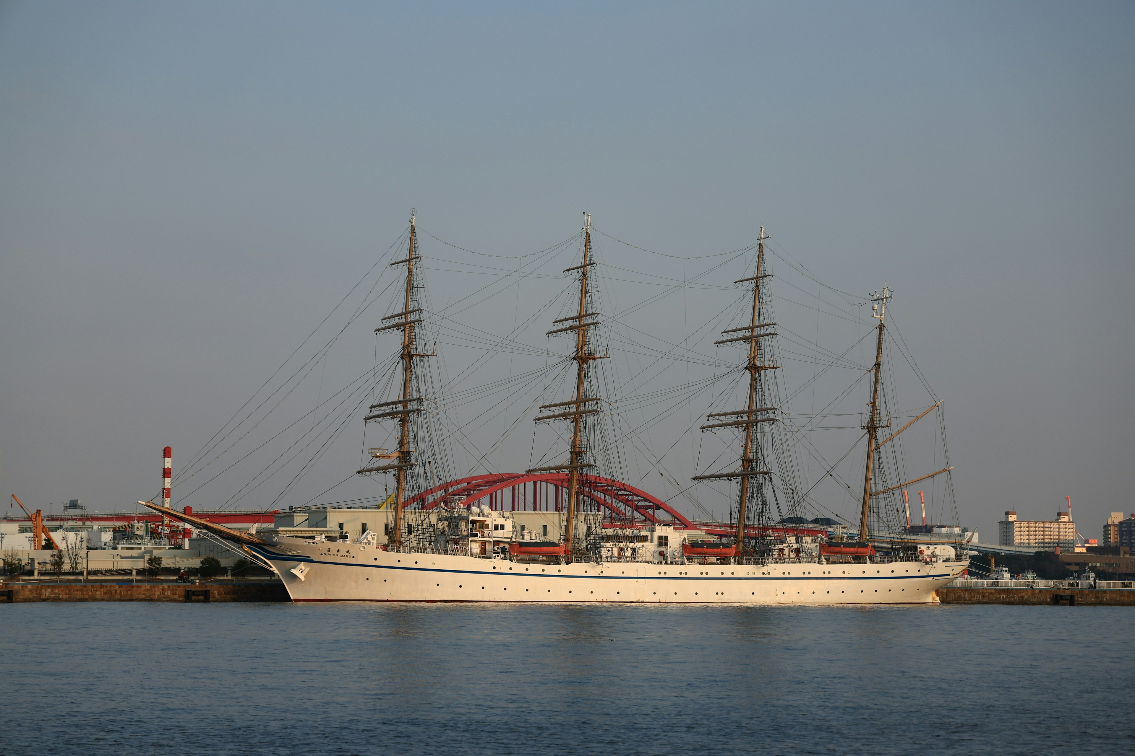 A large sailing ship floating on a calm water surface